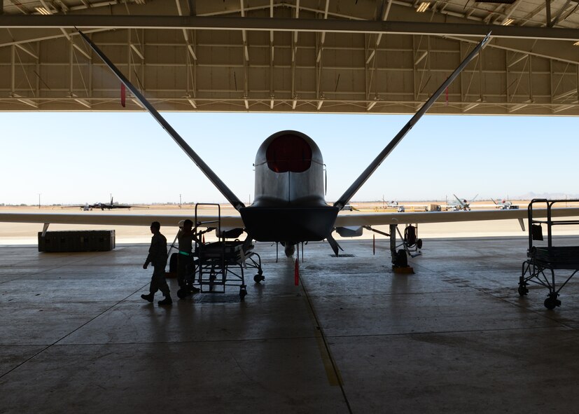 A RQ-4 Global Hawks sits in a hangar as Airmen prepare to install parts Oct. 29, 2015, at Beale Air Force Base, California. The aircraft being worked on recently arrived at Beale to conduct a non-destructive inspection. Beale is used as the maintenance depot for the U.S. Air Force’s RQ-4 fleet. (U.S. Air Force photo by Airman 1st Class Ramon A. Adelan)