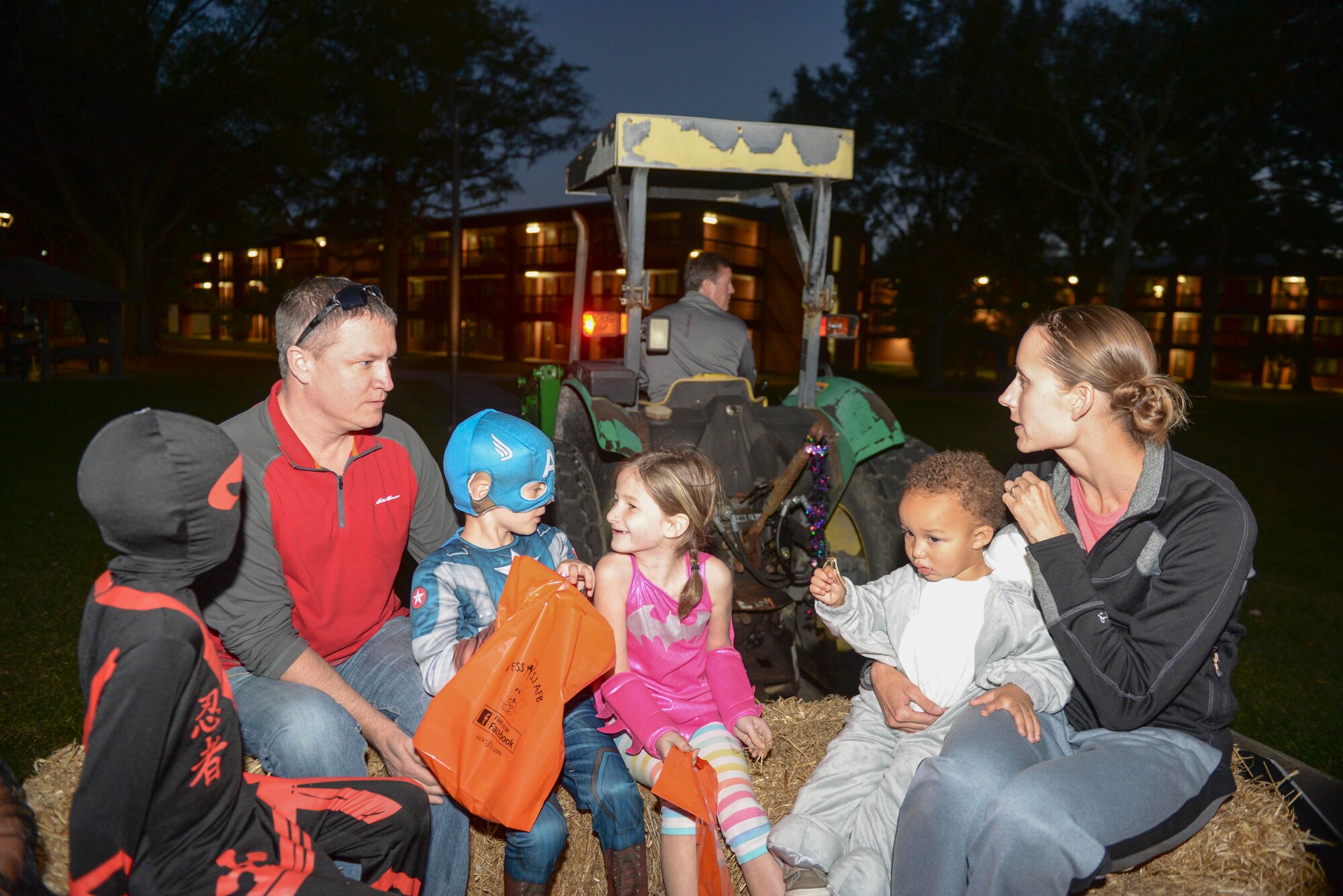 Team Seymour members take a hay ride during the Halloween block party, Oct. 30, 2015, at Seymour Johnson Air Force Base, North Carolina. Hundreds of children and adults came out for the event to show off their costumes and participate in several activities. (U.S. Air Force photo/Airman 1st Class Ashley Williamson)