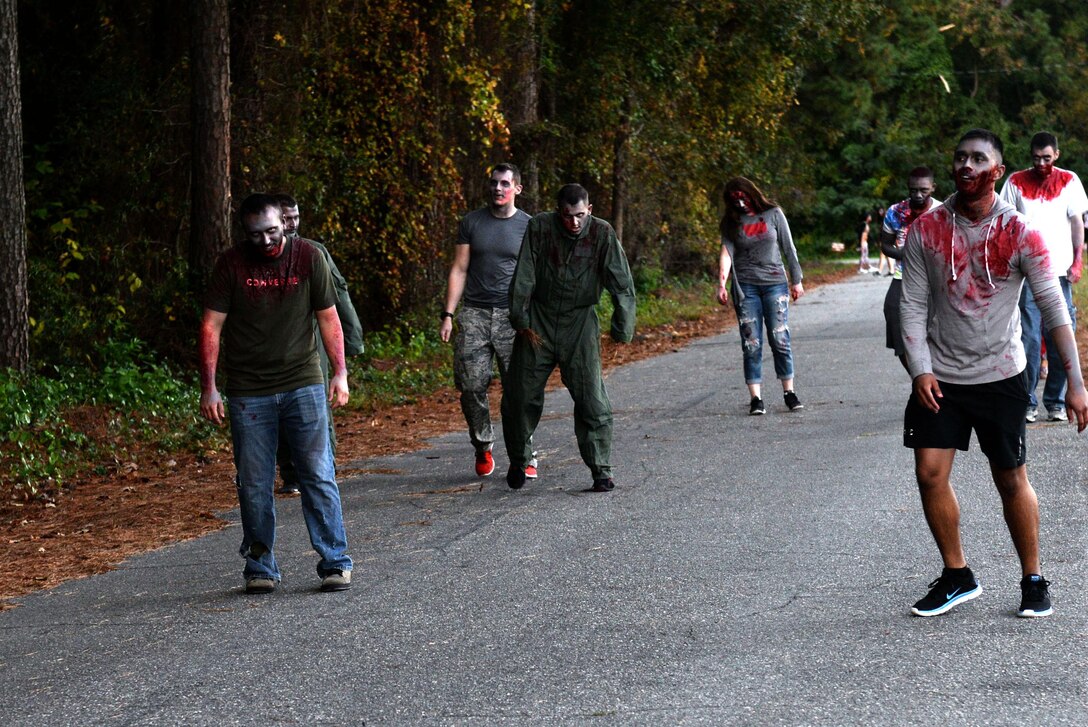 Team Seymour members walk the trail as zombies during the Zombie 5K, Oct. 30, 2015, at Seymour Johnson Air Force Base, North Carolina.  The volunteers for the Zombie 5K were placed all along the running trail to scare and chase Team Seymour members participating in the run. (U.S. Air Force photo/Airman 1st Class Ashley Williamson)
