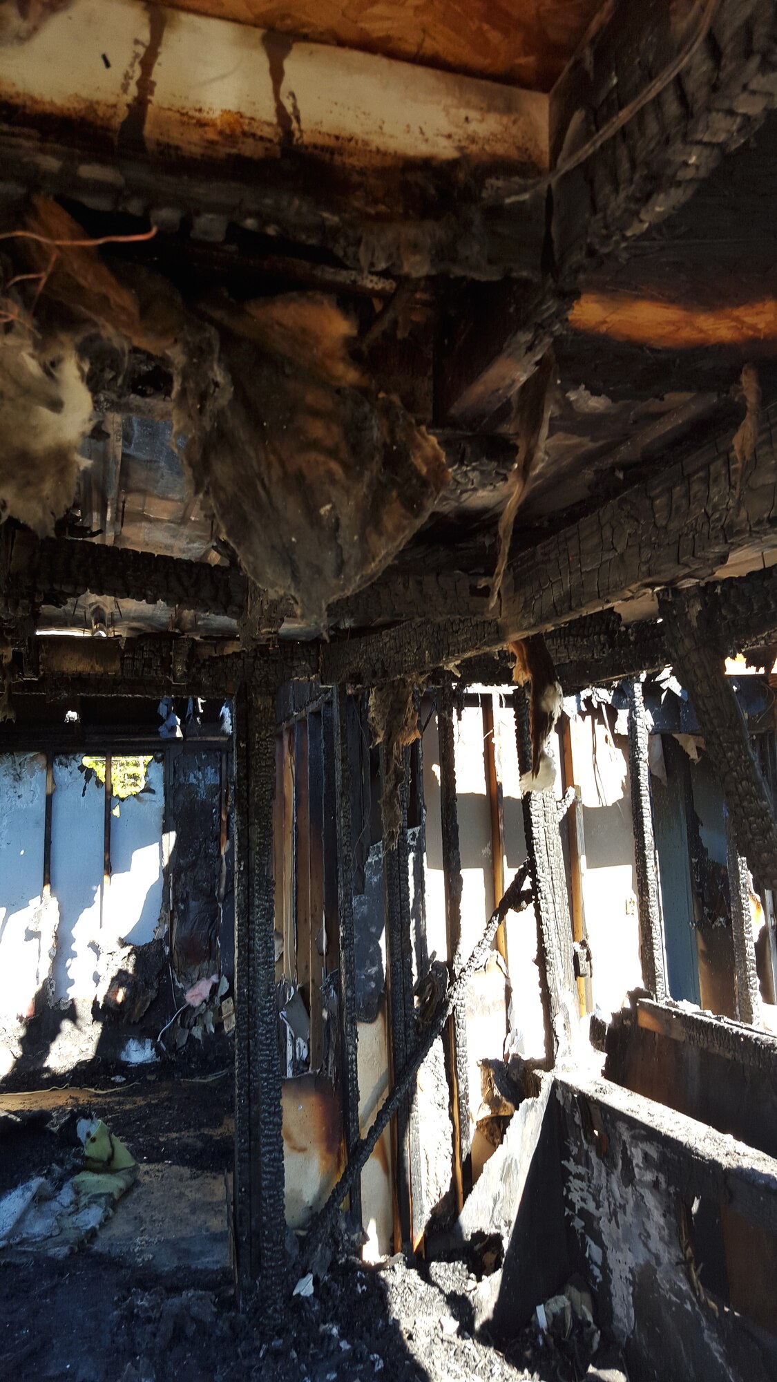 The charred remnants of Joe and Yvonne Mason’s house remain standing, Oct. 17, 2015, in Mar-Mac, North Carolina.  The house caught fire Oct. 11 and was a complete loss for the family. Since then, their neighbor, Tech. Sgt. Justin Manning, 4th Equipment Maintenance Squadron aerospace ground equipment technician, has worked to help the family clear the rubble and make sure they are taken care of. (Courtesy photo)