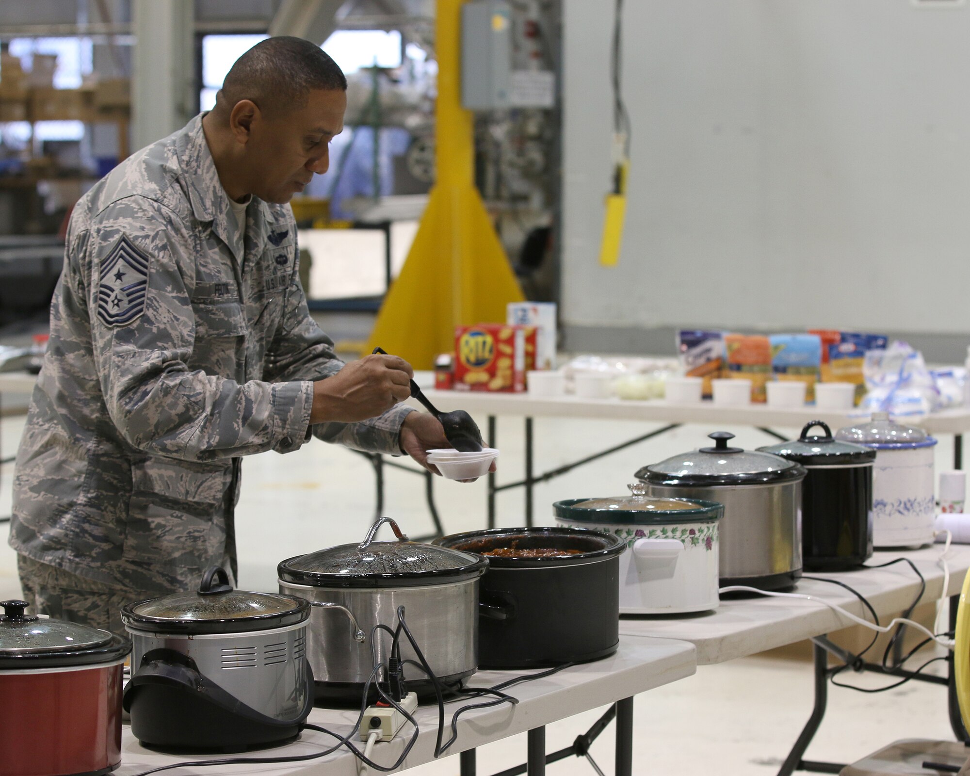 WRIGHT-PATTERSON AIR FORCE BASE, Ohio – Chief Master Sgt. James Felton, 445th Airlift Wing Command Chief, samples one of 18 pots of chili, while serving as a judge during the 445th Airlift Wing’s 15th Annual Chili Cook-off Oct. 29, 2015. The event raised more than $350 for the Combined Federal Campaign. (U.S. Air Force photo/Tech. Sgt. Patrick O’Reilly)