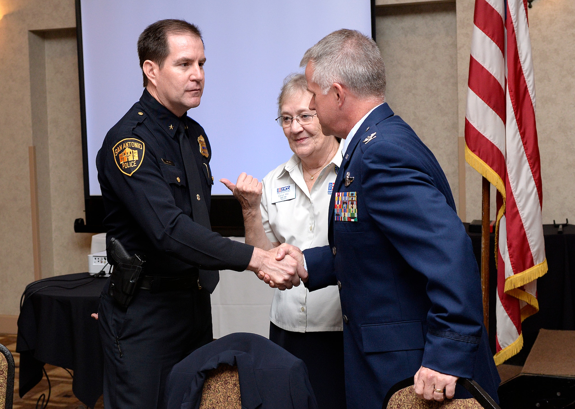 Deputy Chief Anthony Trevino, San Antonio Police Department, is introduced to Col. David Scott, 433rd Airlift Wing vice commander, by Caryl Hill, Employer Support of the Guard and Reserve San Antonio Texas Committee Area 4 Chair Nov. 3, at the Double Tree Hotel San Antonio, Texas. The ESGR hosts the Salute to Employers Awards Luncheon as a way to recognize local businesses that employ and support their Reserve and National Guard employees.  (U.S. Air Force photo by Benjamin Faske) (released)