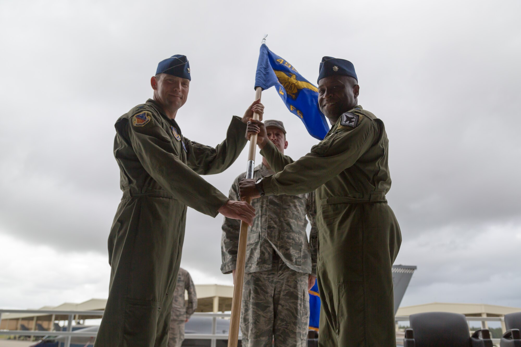 Col. Dave Smith, the 482nd Operations Group commander, passes the 367th Guidon to Lt. Col. Henry Jeffress, commander of the newly reactivated 367th Fighter Squadron, during a reactivation ceremony Oct. 23 in Hangar 200 at Homestead Air Reserve Base, Fla. The unit known as Detachment 93 prior to the ceremony, maintains and flies F-16 Fighting Falcons. (U.S. Air Force photo by Tech. Sgt. Lionel Castellano)