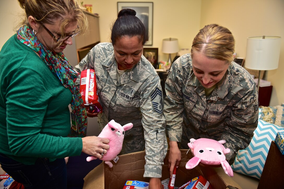 Yolanda Gunzel, Director of Psychological Health, along with Chief Master Sgt. Angela Woods and Staff Sgt. Jolean Terbrak, both with the 932nd Medical Squadron, sort through a box with some items donated by the H.E.R.O.E.S. Care program. Homefront Enabling Relationships, Opportunities, and Empowering Support, H.E.R.O.E.S is a community-based strategy to support military families through many of the psychological, moral and spiritual injuries that are associated with deployments.  Over a 1000 diapers and some toys will be distributed to new parents within the 932nd Airlift Wing. (U.S. Air Force photo by Christopher Parr)