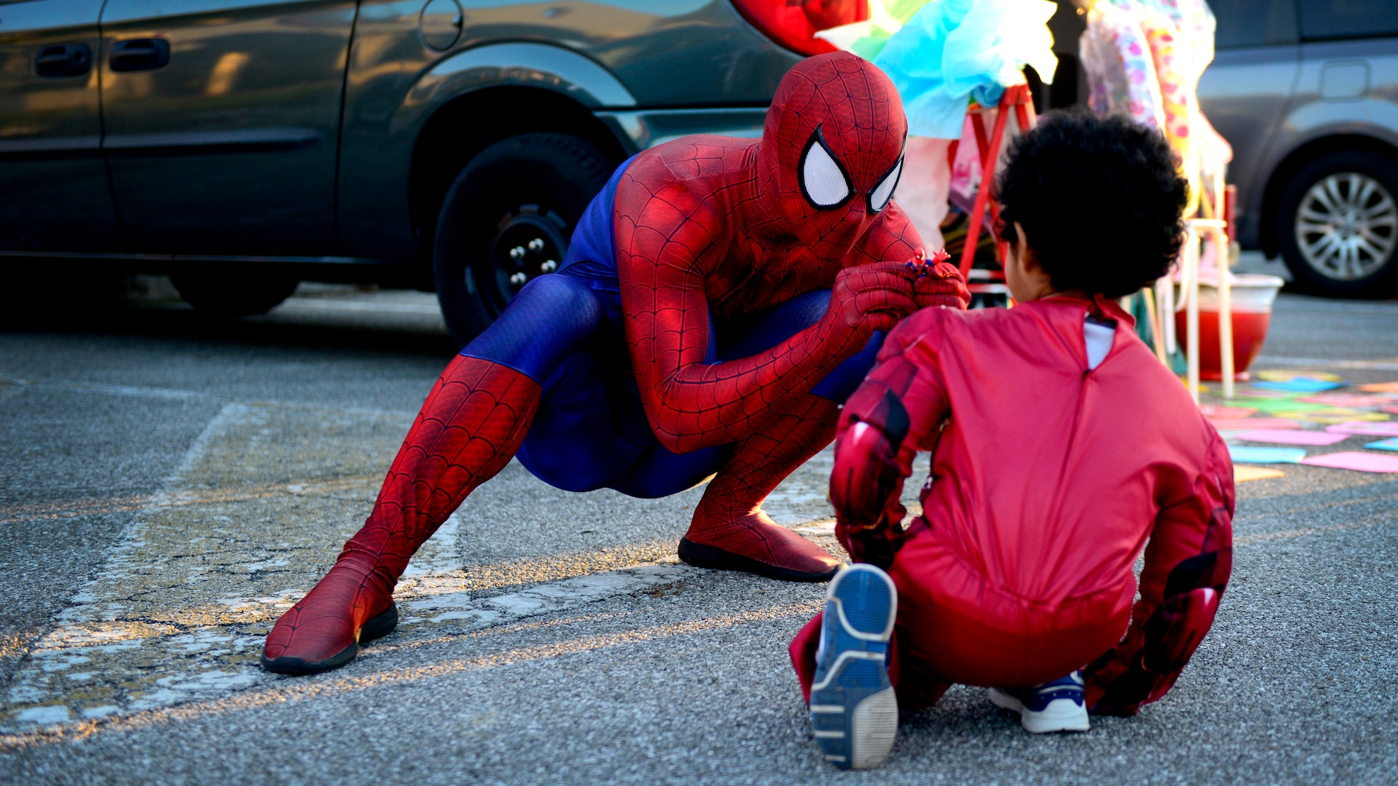 Spider-Man interacts with a young Wyvern Warrior during Trunk-or-Treat, Oct. 31, 2015, at Aviano Air Base, Italy. During the event young Wyvern Warriors trick-or-treated from parked car to parked car as an alternative to going from house-to-house. (U.S. Air Force photo by Senior Airman Areca T. Bell/Released)