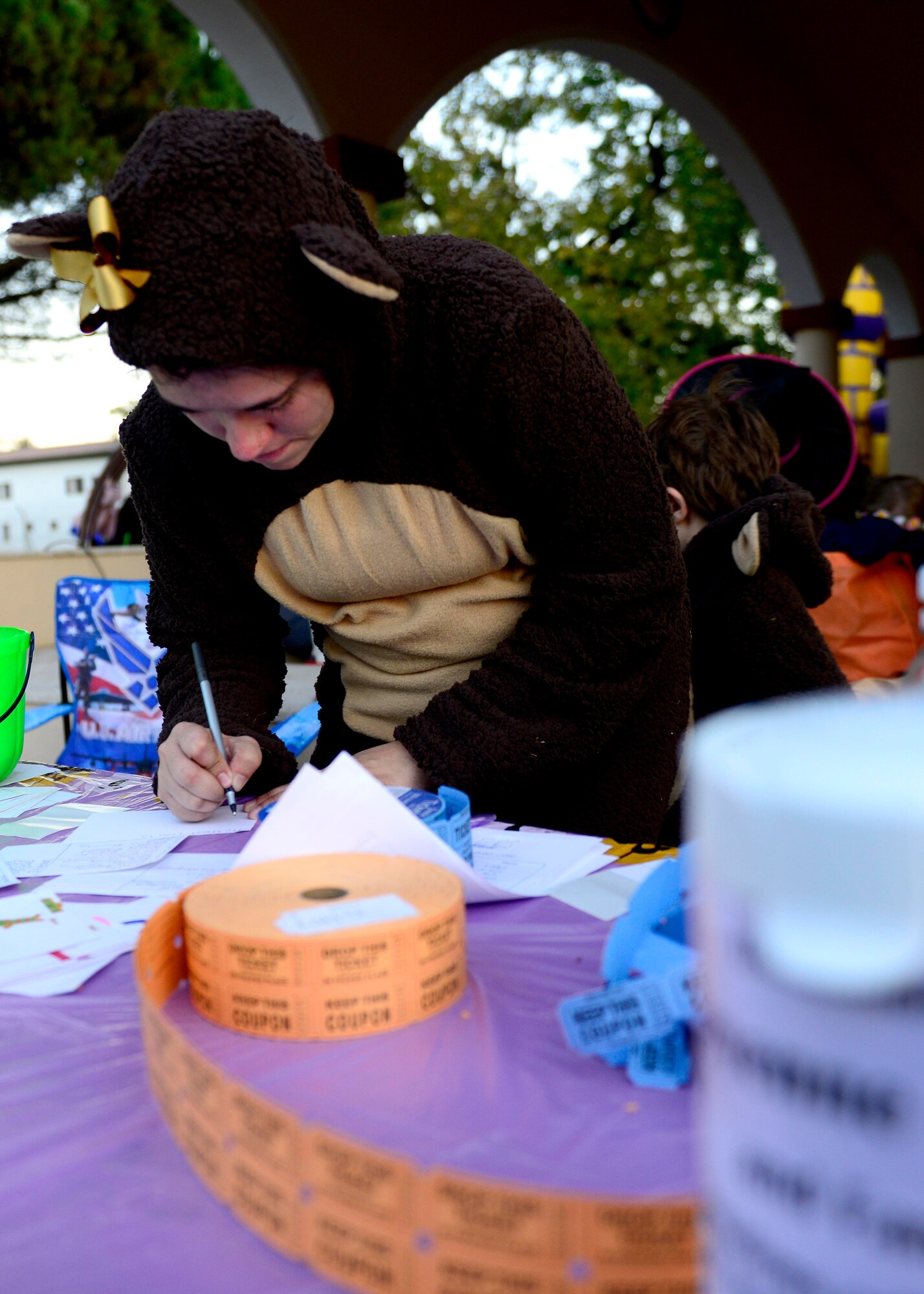 Ashley Feiss checks in trick-or-treaters during Trunk-or-Treat, Oct. 31, 2015, at Aviano Air Base, Italy. The event featured a costume contest, games and a Halloween party. (U.S. Air Force photo by Senior Airman Areca T. Bell/Released)