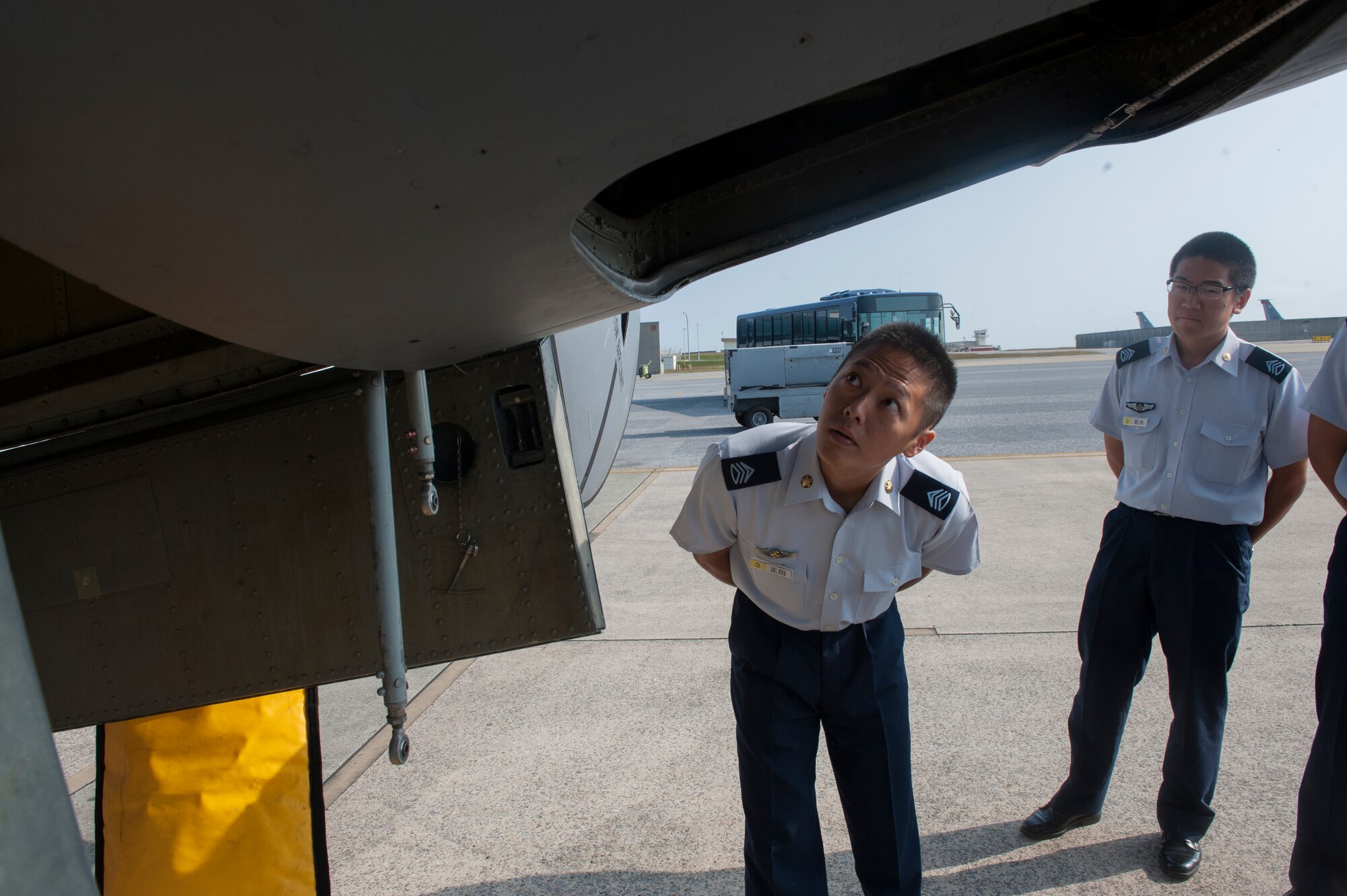 Members of the Japan Air Self-Defense Force look at the KC-135 Stratotanker during a tour of the 909th Air Refueling Squadron Oct. 29, 2015, at Kadena Air Base, Japan. The JASDF members were given a short briefing followed by a static display tour of a KC-135 Stratotanker. (U.S. Air Force photo by Airman 1st Class Corey M. Pettis)