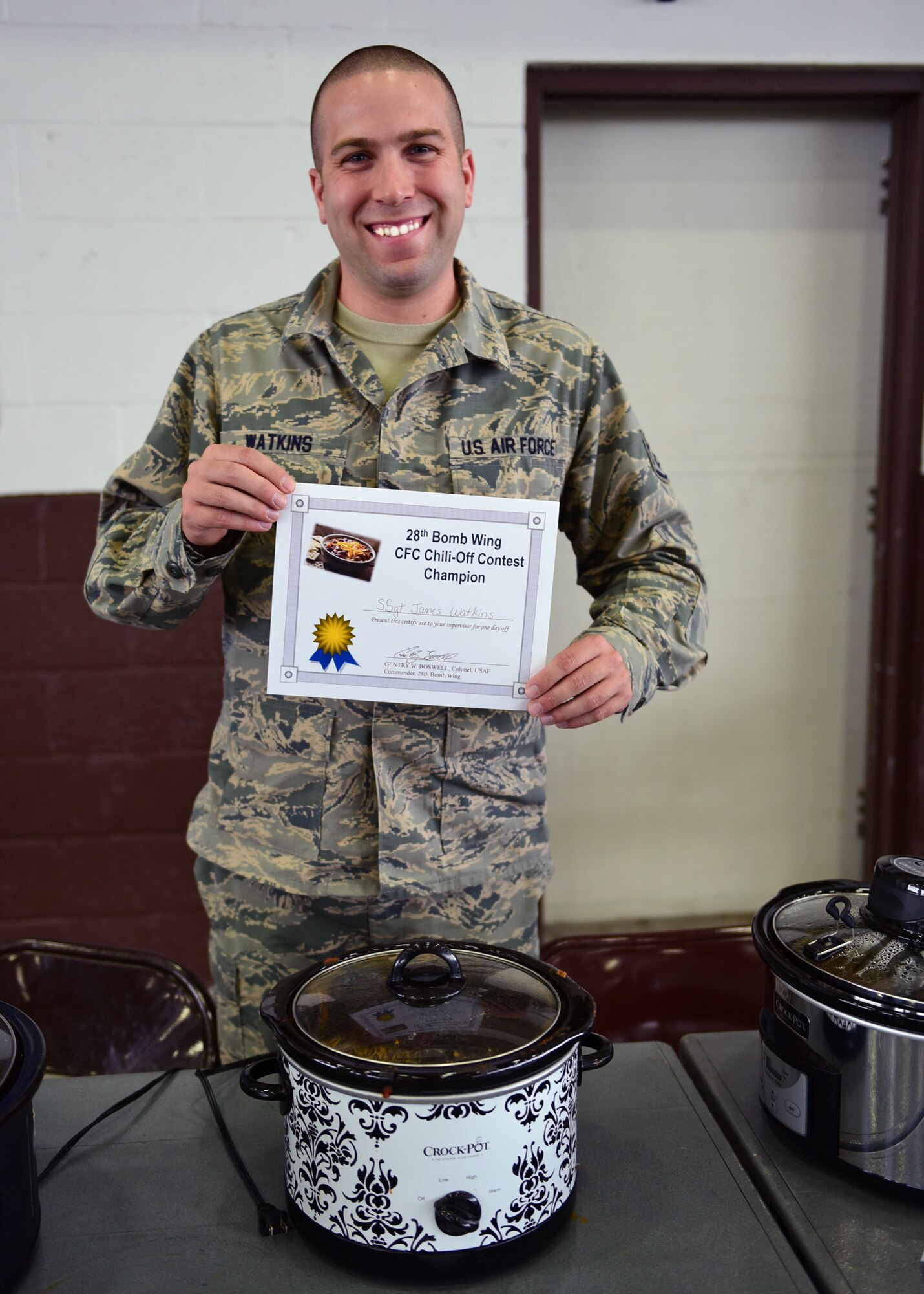 Staff Sgt. James Watkins, 28th Logistics Readiness Squadron flight service center NCO in charge, poses with his award-winning chili at the Combined Federal Campaign Chili Cook-Off at Ellsworth Air Force Base, S.D., Oct. 26, 2015. Watkins competed against 11 participants at the event, helping raise $311 for the CFC. (U.S. Air Force photo by Airman 1st Class James L. Miller/Released) 
