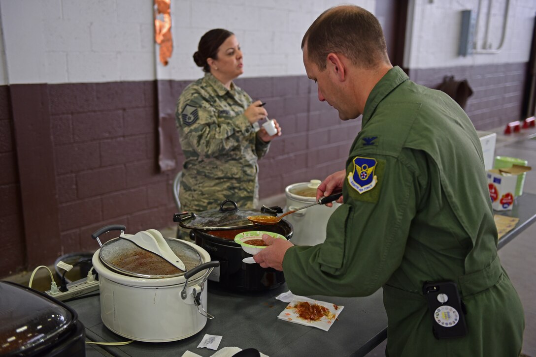 Col. Gentry Boswell, 28th Bomb Wing commander, dishes out chili at the Combined Federal Campaign Chili Cook-Off at Ellsworth Air Force Base, S.D., Oct. 26, 2015. The event proceeds were donated to the CFC, which benefits charities all over the world. (U.S. Air Force photo by Airman 1st Class James L. Miller/Released)