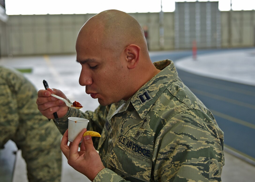 Capt. Benjamin Quintanilla, 28th Bomb Wing chaplain, samples chili at the Combined Federal Campaign Chili Cook-Off at Ellsworth Air Force Base, S.D., Oct. 26, 2015. Quintanilla was one of three judges for the event, which raised more than $300 for the CFC. (U.S. Air Force photo by Airman 1st Class James L. Miller/Released)