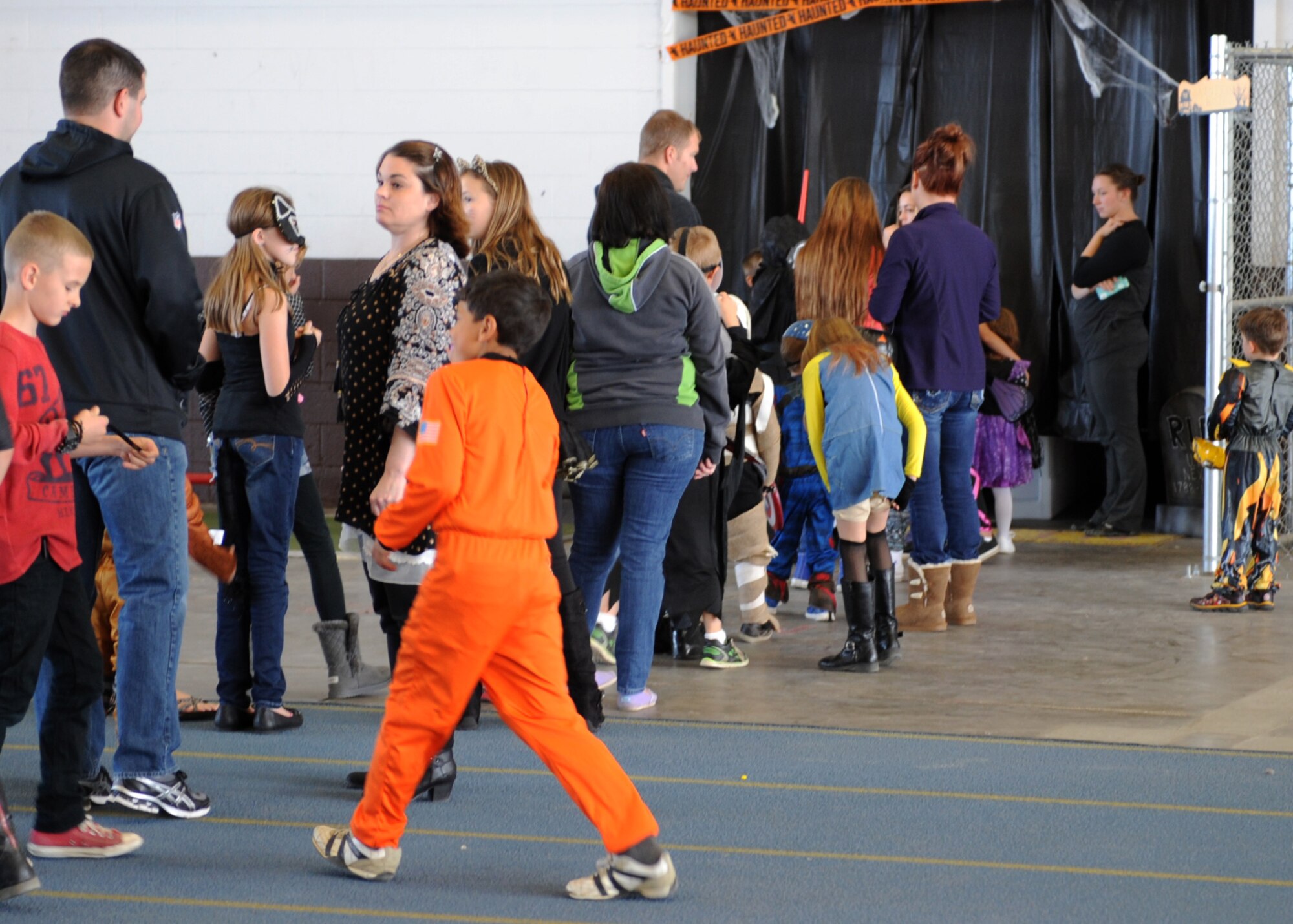 Children and families wait in line to enter a haunted house at the 28th Bomb Wing Children’s Halloween Festival at Ellsworth Air Force Base, S.D., Oct. 24, 2015. The event was designed to provide a fun and exciting atmosphere for Ellsworth children and families. (U.S. Air Force photo by Airman 1st Class Denise M. Nevins/Released)