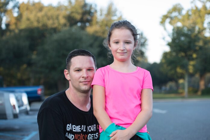 Staff Sgt. Carl Ellis, 628th Logistics Readiness Squadron quality assurance evaluator, poses for a photo with his daughter, Hannah Ellis after the Halloween 5K at Joint Base Charleston – Air Base, S.C., on Oct. 30, 2015. Hannah, was the youngest person to participate in this years run which was a kickoff event for the fitness centers “Healthy through the Holidays” campaign. (U.S. Air Force photo/Airman 1st Class Thomas Charlton)