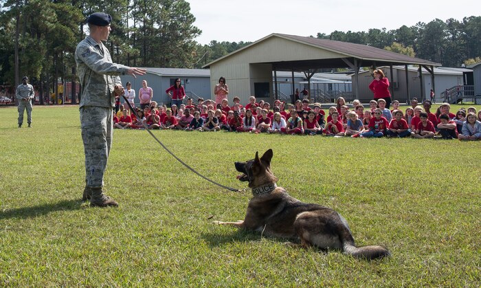 Staff Sgt. Konnor Torkelson, 628th Security Forces Squadron military working dog handler, explains how his dog, Hulk, listens only to his commands at Marrington Elementary School on Joint Base Charleston – Naval Weapons Station, S.C., on Oct. 29, 2015. The 628th SFS traveled to MES to raise awareness of what illegal substance abuse can do are during Red Ribbon Week. (U.S. Air Force photo/Airman 1st Class Thomas Charlton)
