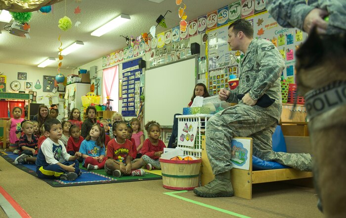 Staff Sgt. Kyle Shaugnessy, 628th Security Forces Squadron military working dog instructor, speaks to Dee Donnahoo’s pre-school class about the dangers of drugs during Red Ribbon Week at Marrington Elementary School on Joint Base Charleston –Weapons Station, S.C., on Oct. 29, 2015. Shaugnessy has been with the military working dog program for four years. (U.S. Air Force photo/Airman 1st Class Thomas Charlton)