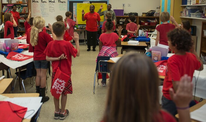 Christine Williams, 628th Air Base Wing drug testing program administrative manager, and Master Sgt. Maurine Ferguson, 315th Aerospace Medicine Squadron drug demand manager, administer the drug awareness pledge for Kristen DelliColli’s class at Marrington Elementary School on Joint Base Charleston – Weapons Station, S.C., on Oct. 29, 2015. The class is wearing red in support of Red Ribbon Week, an annual drug awareness event. (U.S. Air Force photo/Airman 1st Class Thomas Charlton)