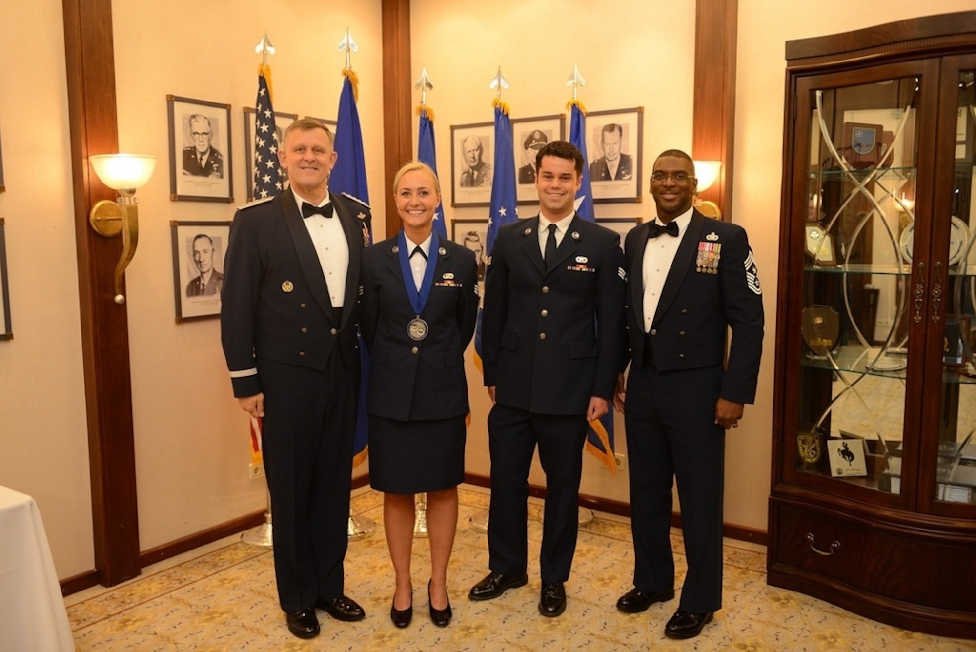 Gen. Frank Gorenc and Chief Master Sgt. James Davis, U.S. Air Forces in Europe and Air Forces Africa command team, pose for a photo with Senior Airman Shabree Heasell and her husband at the 2014 Outstanding Airmen of the Year banquet at Ramstein Air Base, Germany. Senior Airman Shabree Heasell was one of only 10 chosen across the Air Force for this brand new program. Each major command commander was given the opportunity to select just one enlisted Airman from their command to attend officer training school. (Courtesy photo)