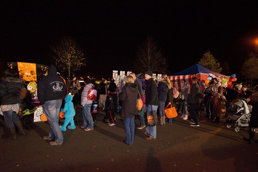 Trick-or-treaters and their family members wait in line to go through the “Trunk-or-Treat” event during Family Fright Night at the Club Eifel parking lot on Spangdahlem Air Base, Germany, Oct. 30, 2015. More than 400 members of the Spangdahlem community attended the event. (U.S. Air Force photo by Staff Sgt. Christopher Ruano/Released)