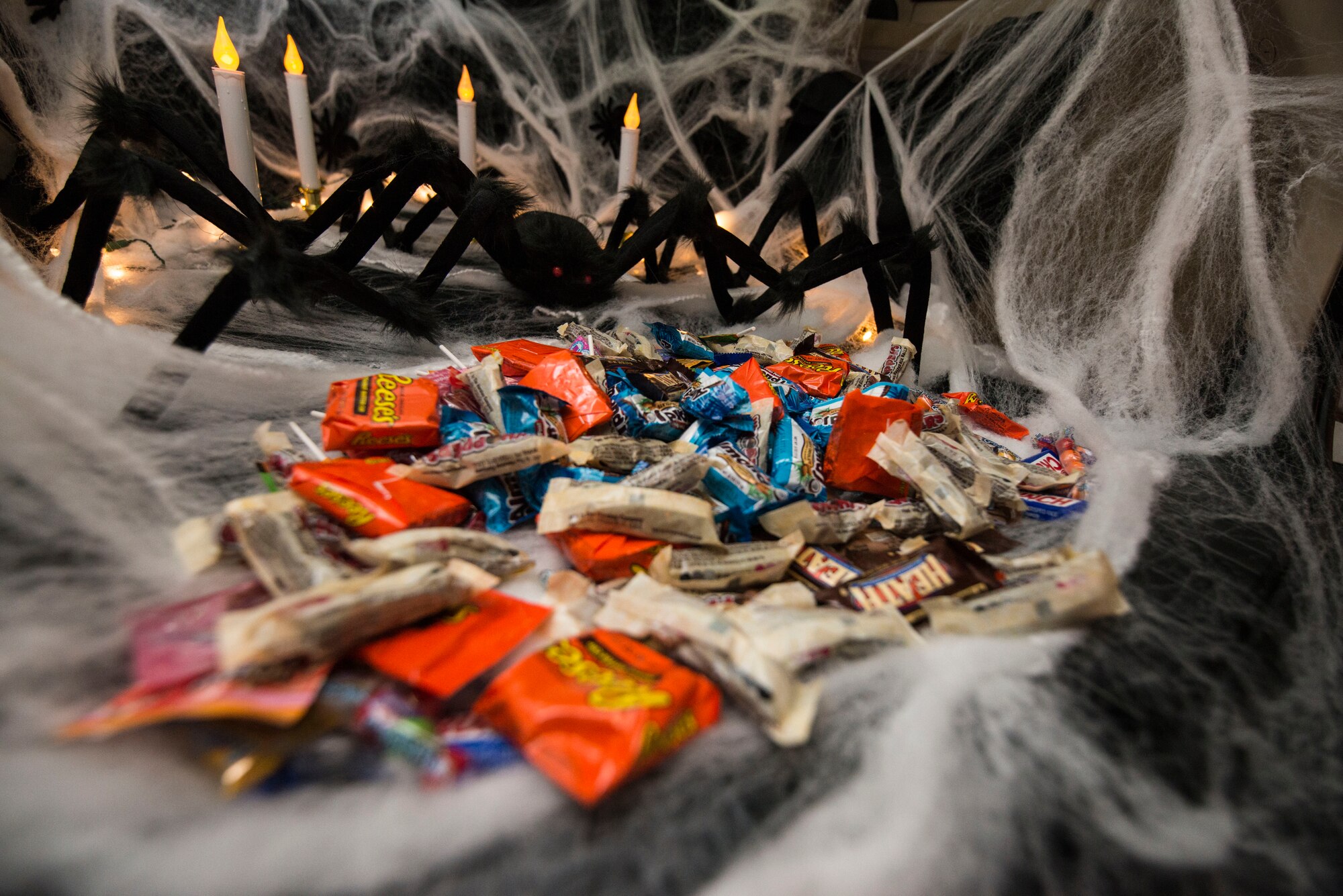 Assorted candy is placed inside a car trunk for “Trunk-or-Treat” during Family Fright Night at the Club Eifel parking lot on Spangdahlem Air Base, Germany, Oct. 30, 2015. More than 11 vehicles and 40 volunteers participated in the “Trunk-or-Treat” event. (U.S. Air Force photo by Staff Sgt. Christopher Ruano/Released)