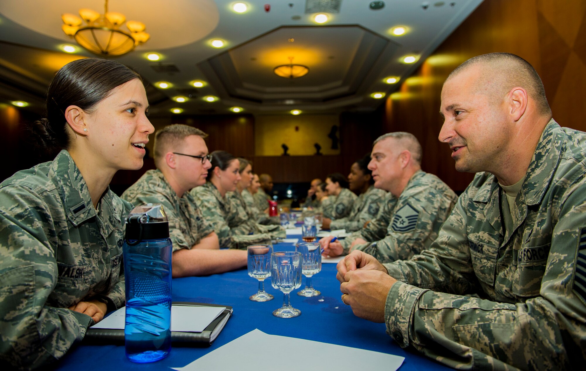 U.S. Air Force 1st Lt. Stephanie Walsh, 52nd Force Support Squadron force development flight chief, left, and U.S. Air Force Chief Master Sgt. Dwight McCormick, 52nd Component Maintenance Squadron propulsion flight chief, converse during a speed mentoring session inside Club Eifel at Spangdahlem Air Base, Germany, Oct. 29, 2015. Company grade officers brought a list of questions to ask the senior NCOs pertaining to leadership. (U.S. Air Force photo by Airman 1st Class Timothy Kim/Released)