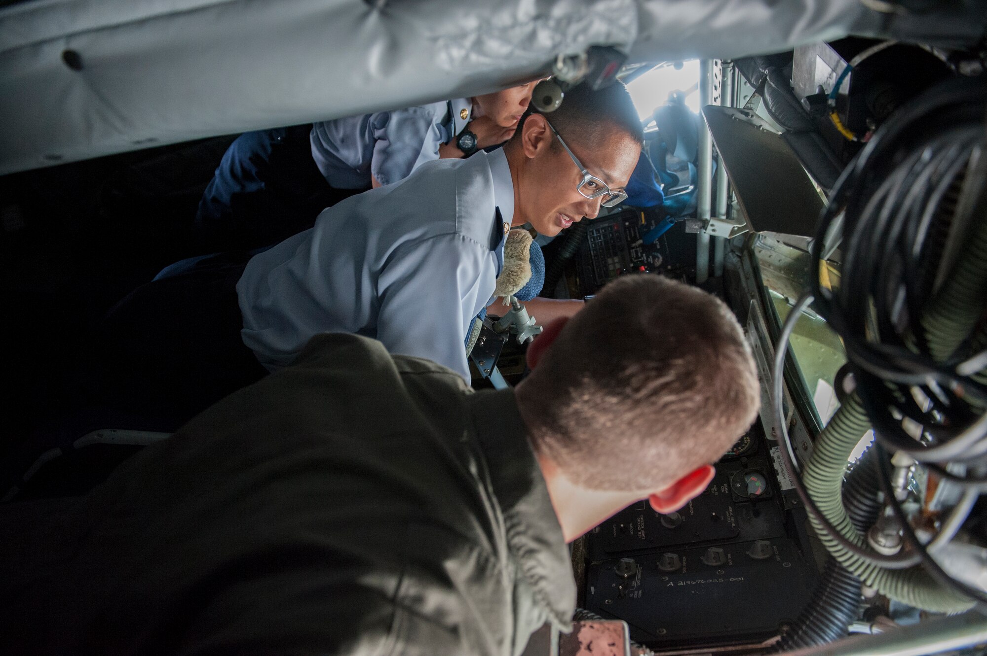 U.S. Air Force Airman 1st Class Peyton Olson, 909th Air Refueling Squadron boom operator, shows Japan Air Self-Defense Force members the controls to the boom of a KC-135 Stratotanker during a tour of the 909th Air Refueling Squadron Oct. 29, 2015, at Kadena Air Base, Japan. During the tour, JASDF members learned about the capabilities and the mission of the KC-135 Stratotanker. (U.S. Air Force photo by Airman 1st Class Corey M. Pettis)