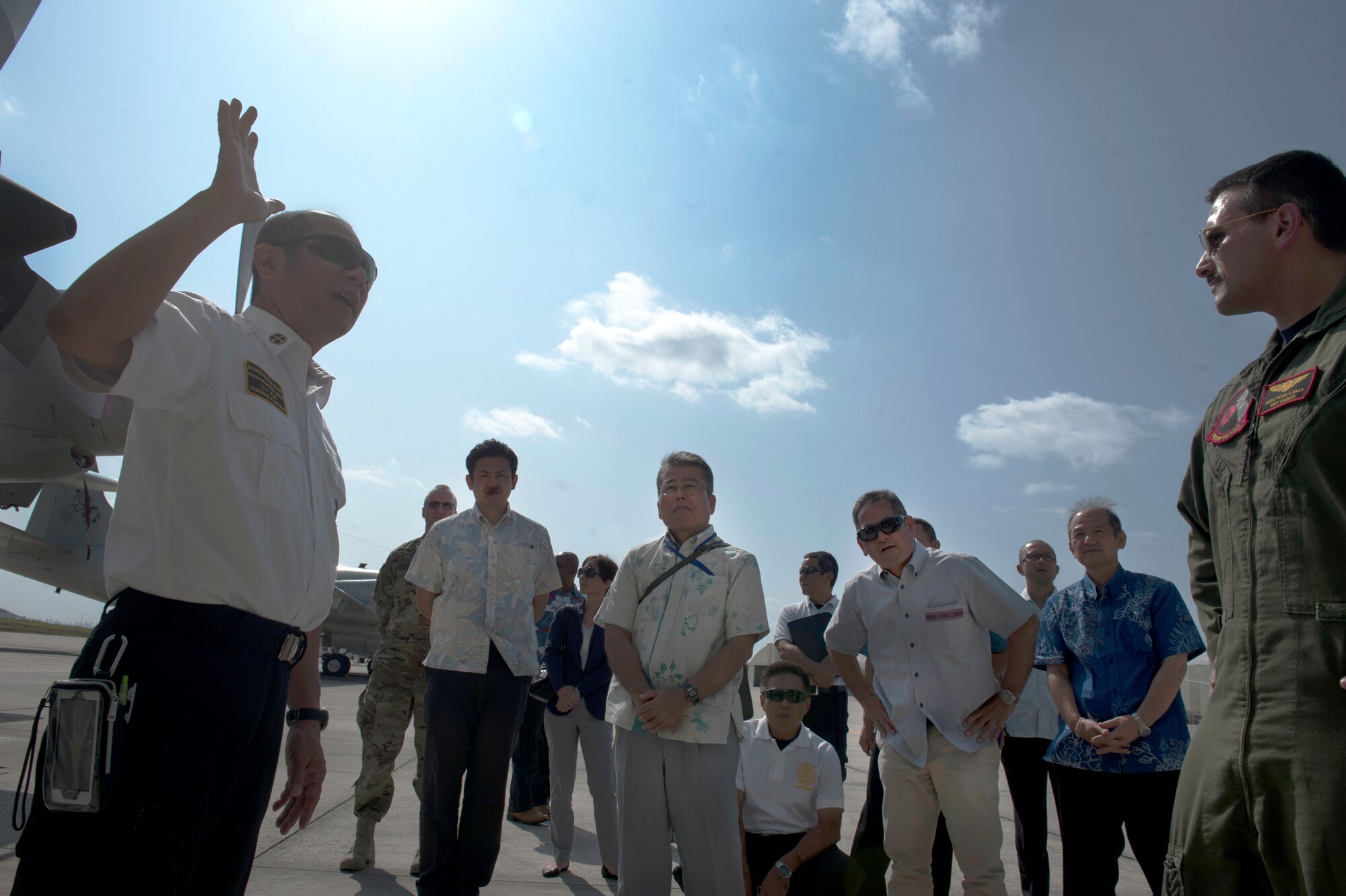 U.S. Navy Petty Officer Second Class Peter Haas, 46th Patrol Squadron acoustic operator, and Mitsuo Yamaguchi, 18th Civil Engineer Squadron fire training section assistant, discuss the different parts of a P-3 aircraft during a bilateral aircraft egress training event Oct. 29, 2015, at Kadena Air Base, Japan. This training allowed Air Force, Navy, and Okinawan emergency response forces to work together and coordinate responses.  (U.S. Air Force photo by Airman 1st Class Lynette M. Rolen)