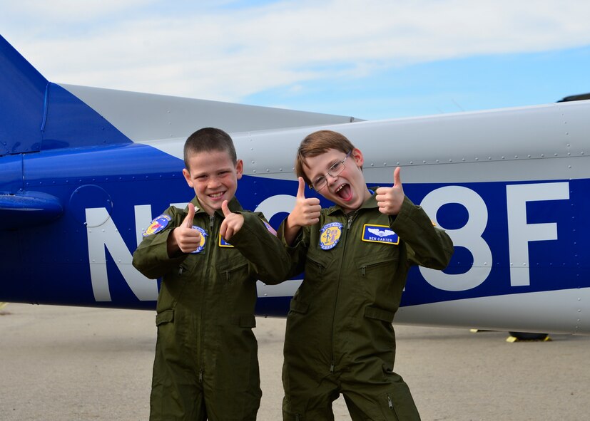 Blake Boyer, left, and Ben Carter, right, give a thumbs up before taking part in a flight from the Aero Club during the Pilot for a Day program Oct. 26, 2015, at Dover Air Force Base, Del. The Aero Club donated their time and a plane to fly the boys around the local Dover area giving them an aerial view of the base and local community. (U.S. Air Force photo/Senior Airman William Johnson) 