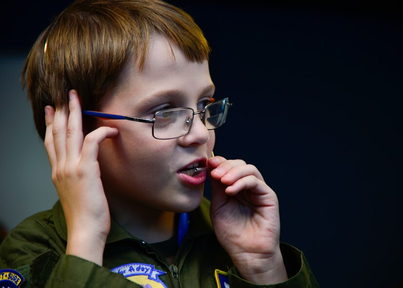 Ben Carter speaks to the 436th Air Traffic Control Tower Simulator during his visit to Team Dover in the Pilot for a Day program Oct. 26, 2015, at Dover Air Force Base, Del. Ben was instructing aircraft to land and take off on the same simulator that Airmen use to train for their jobs. (U.S. Air Force photo/Senior Airman William Johnson)