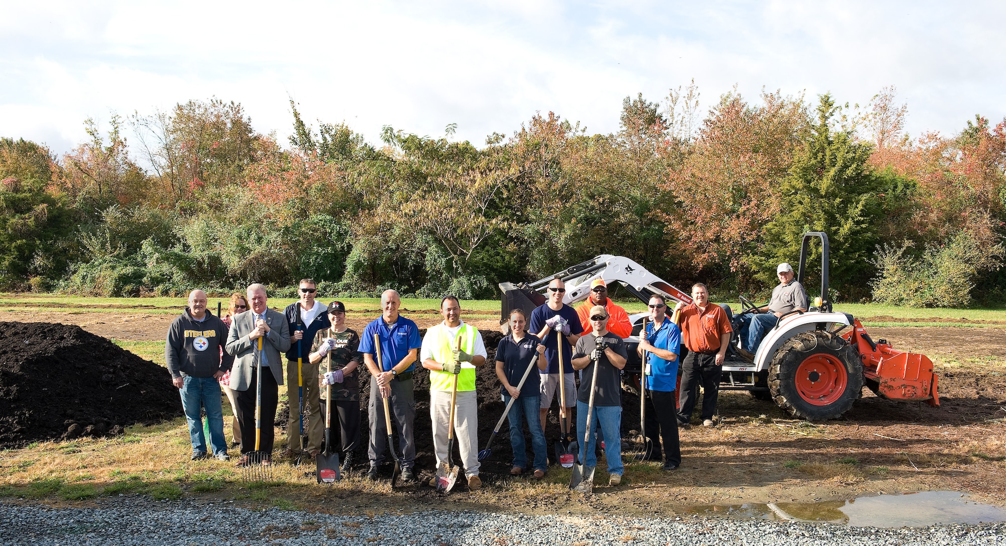 Team Dover Air Force Community Partnership Program P4 community garden initiative stakeholders and volunteers pose for a photo Oct. 29, 2015, on Dover Air Force Base, Del. The new community garden will allow Team Dover members, residents of Eagle Heights family housing, Dover AFB Youth Center patrons, students and teachers at George Welch Elementary School and Dover Air Force Base Middle School, the opportunity to learn and experience gardening by growing fresh organic vegetables under the guidance and educational instruction of gardening enthusiasts and educators from the local area. (U.S. Air Force photo/Roland Balik)