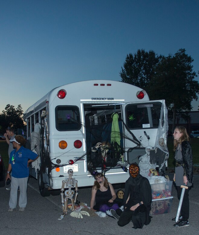 Volunteers from a local youth group give candy out during Trunk or Treat at Joint Base Charleston – Air Base, S.C., on Oct. 30, 2015. The Trunk or Treat event provides a safe trick or treating environment for the local joint base kids. (U.S. Air Force photo/Airman 1st Class Thomas Charlton)