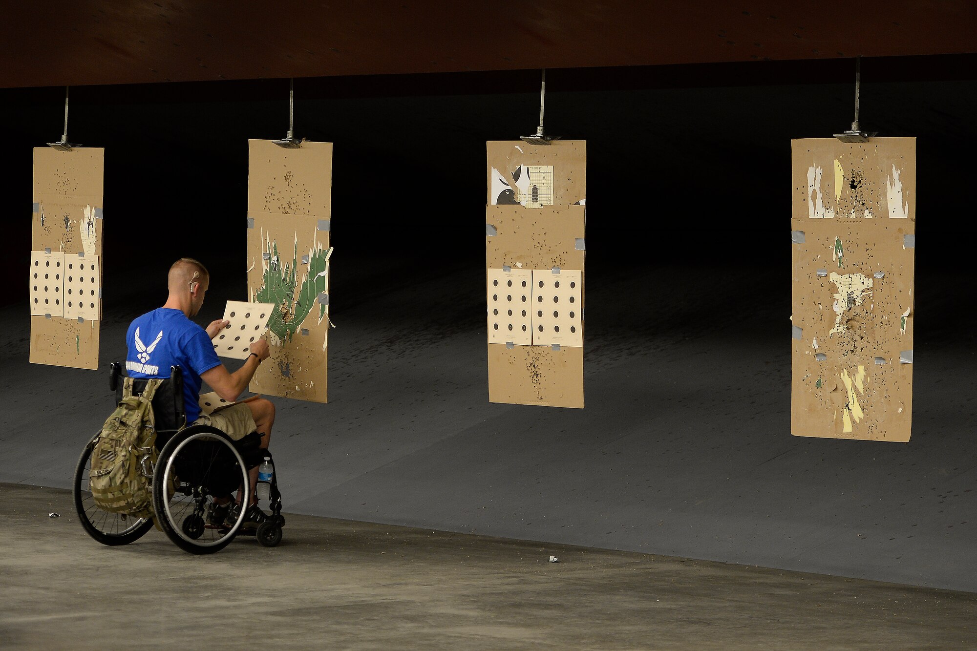 Jeremiah Means, Wounded Warrior athlete, checked his targets during a competition shooting practice Aug. 3 2014 at Fort Collins, Colo. The Air Force Wounded Warrior Program provides support and care for seriously wounded, ill and injured Airmen. The program fully supports the Office of the Secretary of Defense programs to keep highly skilled men and women on active duty or, if not viable, ensure Airmen receive personalized support. (U.S. Air Force photo/Staff Sgt.Tim Chacon)