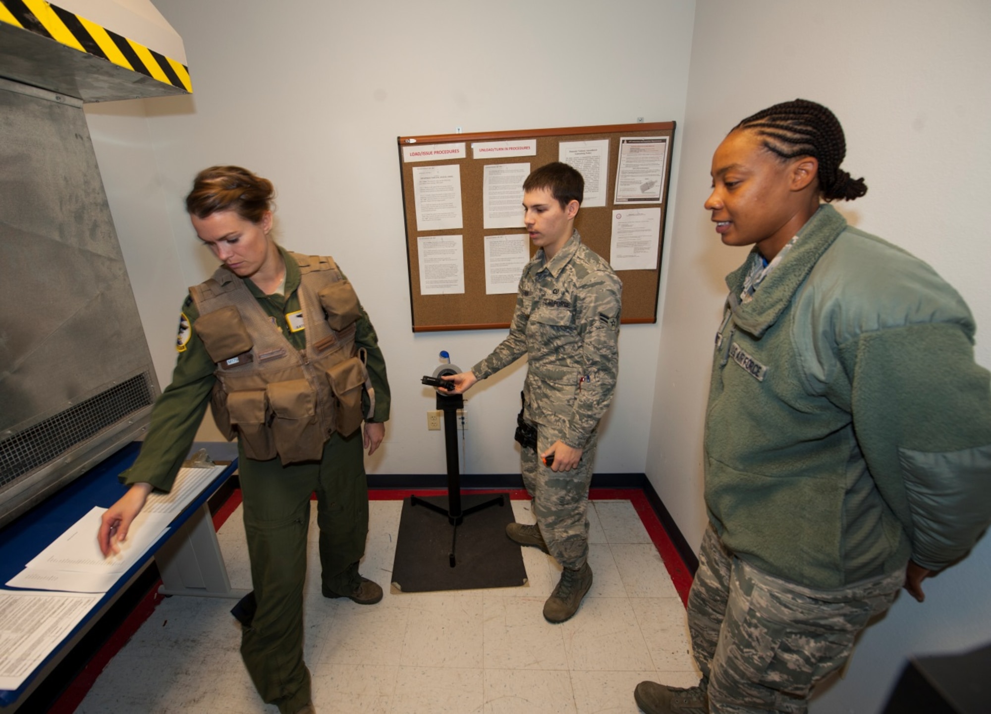 A Minot pilot checks her name on a master list before being trained in the proper procedure of arming and disarming weapons safely at Minot Air Force Base, Oct. 30, 2015. The aircrew flight equipment shop helps train pilots prior to upcoming exercises for safety. (U.S. Air Force photo/Airman 1st Class Christian Sullivan)