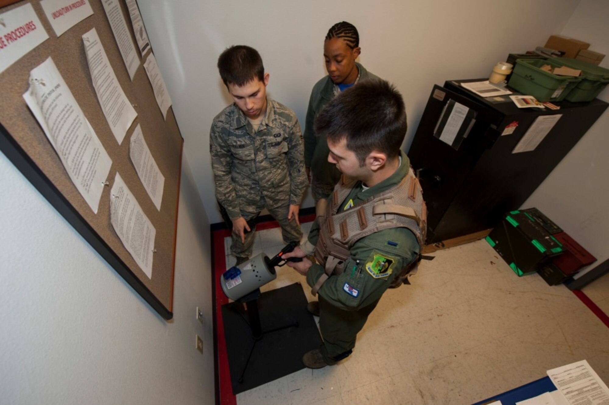 A Minot pilot arms his weapon with dummy rounds during training at Minot Air Force Base, N.D., Oct. 30, 2015. The aircrew flight equipment shop trains pilots in arming and disarming safely for upcoming exercises87. (U.S. Air Force photo/Airman 1st Class Christian Sullivan)