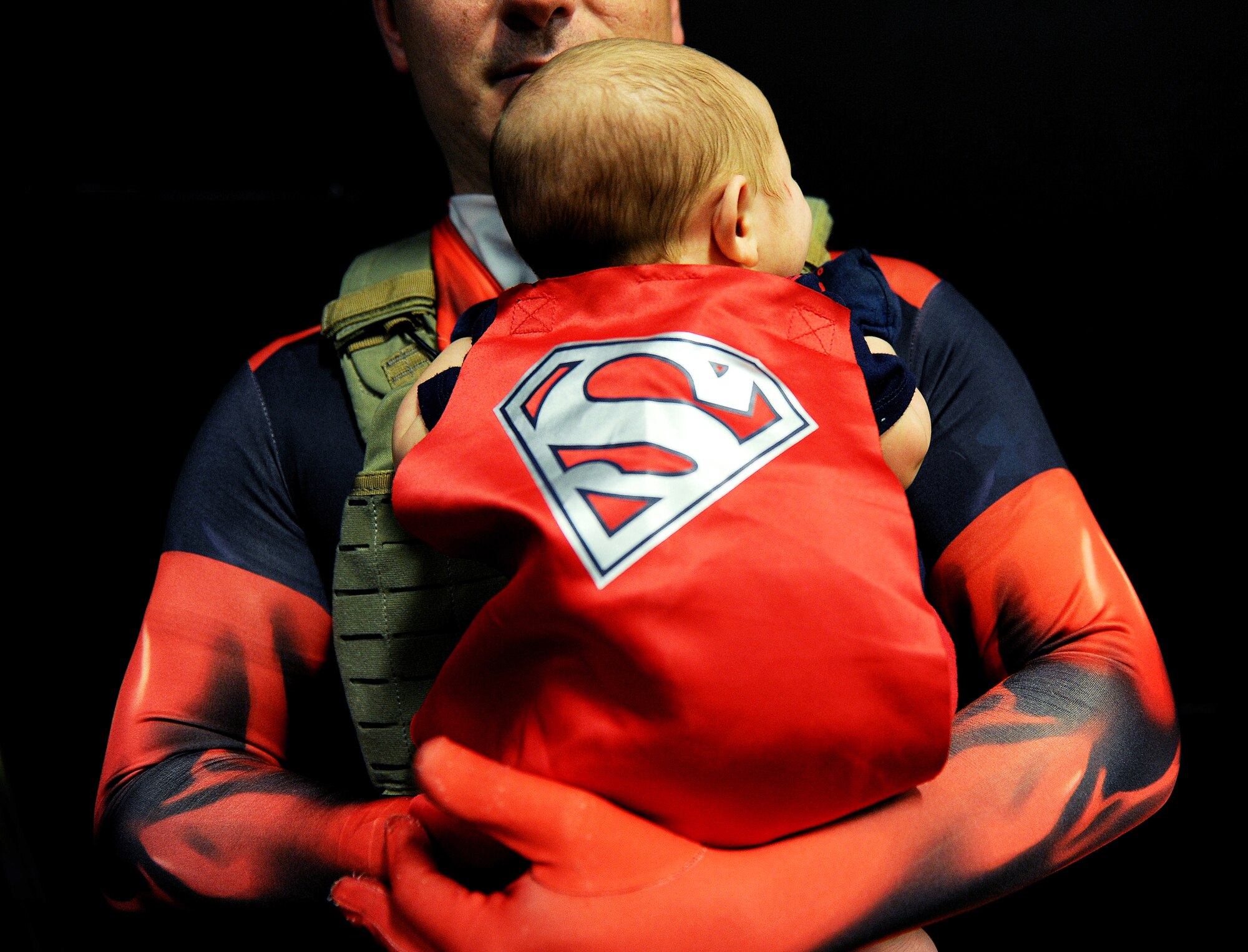 Martin Kyle, Minot resident, holds his child at iMagicon in Minot, N.D. Oct. 30, 2015. iMagicon is a comic book convention that showcases local filmmakers, local businesses and promotes anything pop culture, with several Airmen from Minot Air Force Base volunteered during the two  day event. (U.S. Air Force photo by Staff Sgt. Chad Trujillo)