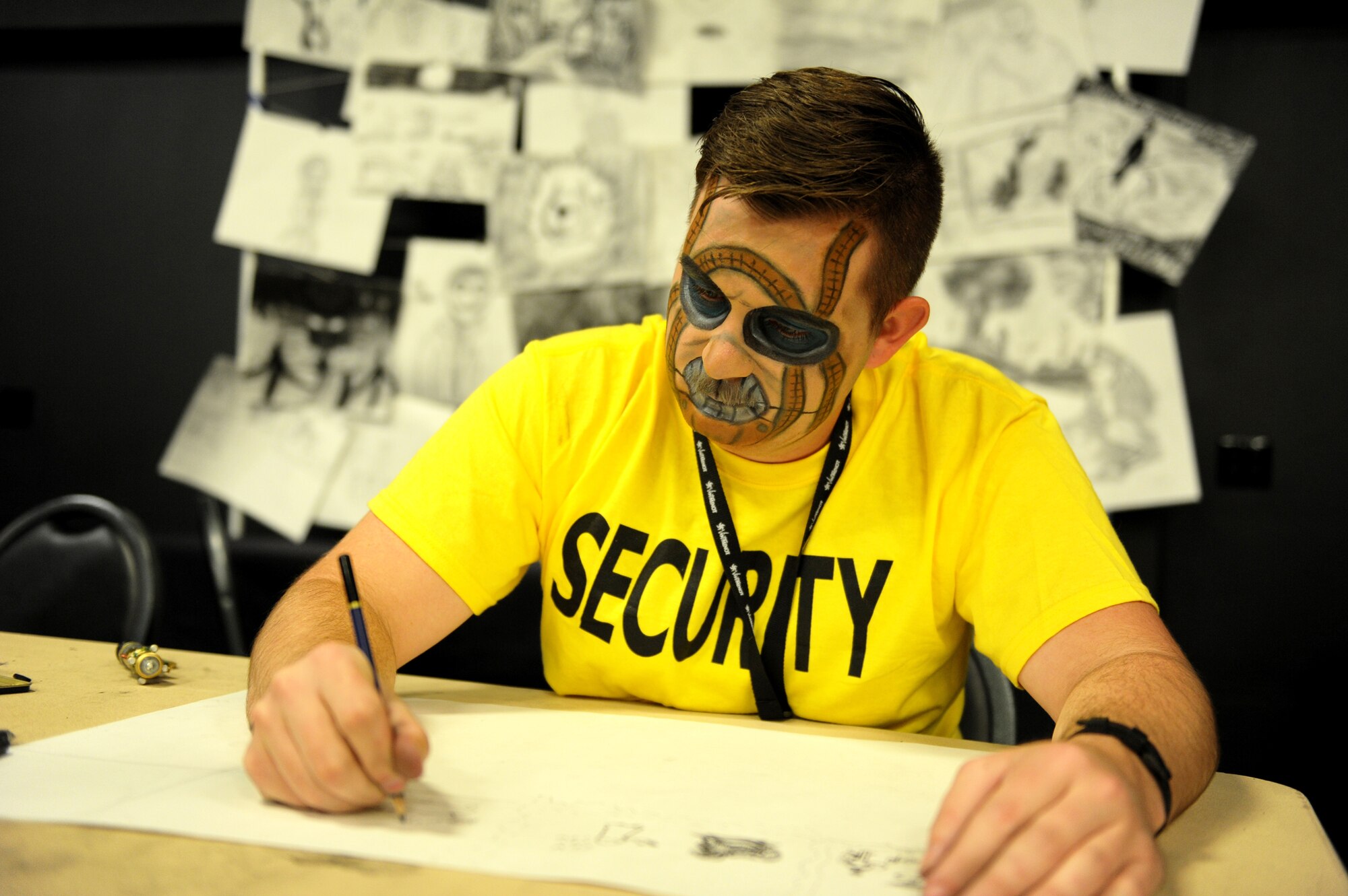 Staff Sgt. Palmer Durrence, 5th Logistics Readiness Squadron, draws a picture during the drawing competition at iMagicon at Minot, N.D. Oct. 30, 2015. iMagicon is a comic book convention that showcases local filmmakers, local businesses and promotes anything pop culture, with several Airmen from Minot Air Force Base volunteering during the 2 day event. (U.S. Air Force photo by Staff Sgt. Chad Trujillo)