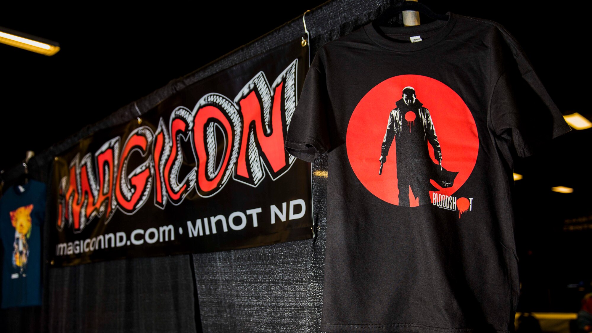 iMagicon sign and t-shirt at iMagicon at Minot, N.D. Oct. 30, 2015. iMagicon is a comic book convention that showcases local filmmakers, local businesses and promotes anything pop culture, with several Airmen from Minot Air Force Base volunteering during the 2 day event. (U.S. Air Force photo by Airman 1st Class J.T. Armstrong)