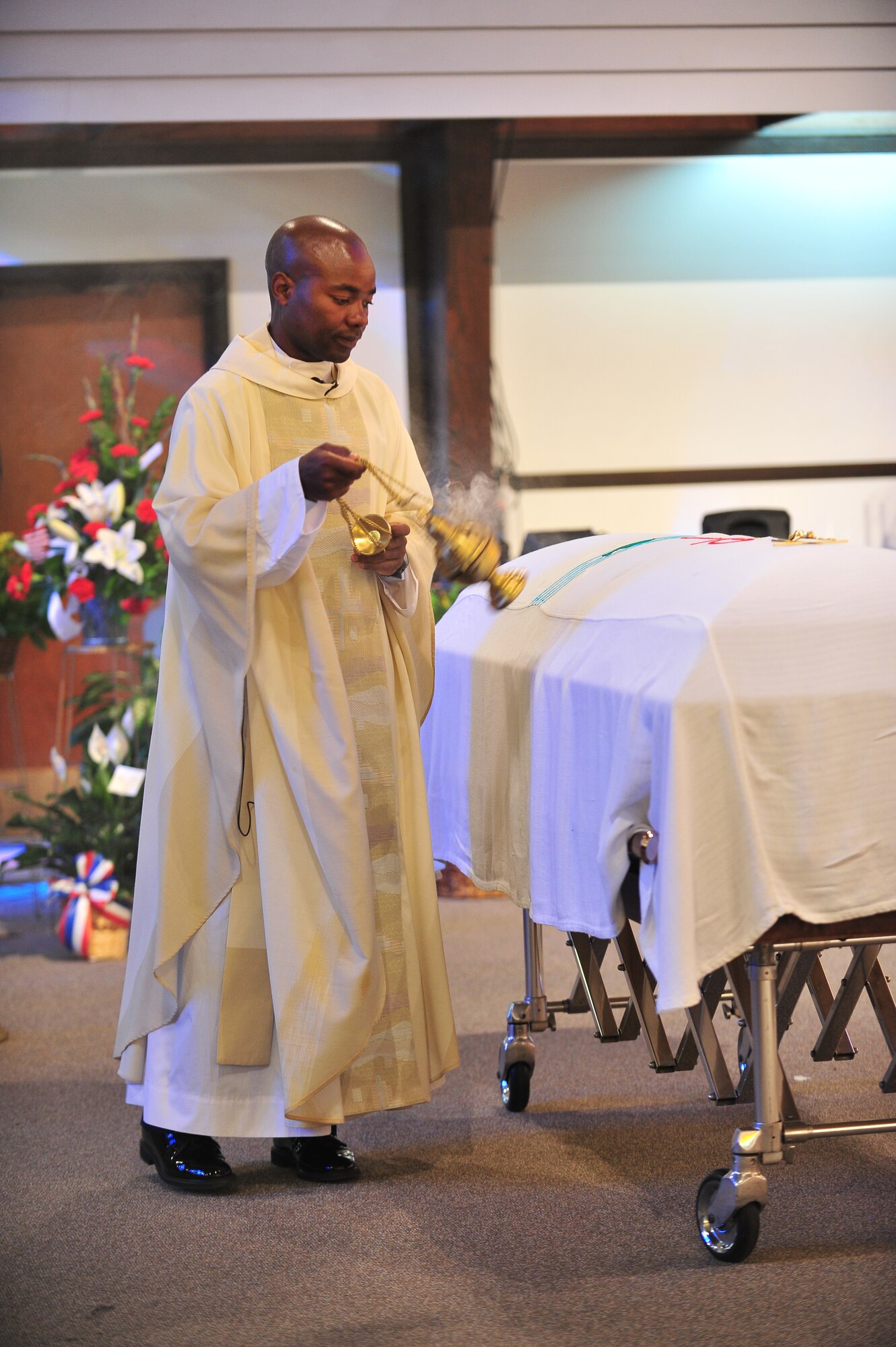 Father Robbie Deka, celebrant of the liturgies, waves incense over the casket of Master Sgt. Matthew Gonzalez during his funeral at Minot Air Force Base, N.D., Oct. 26, 2015. Gonzalez was born January 26, 1979, in Neenah, Wis. and enlisted in the Air Force in September 1997. (U.S. Air Force photo/Senior Airman Stephanie Morris)
