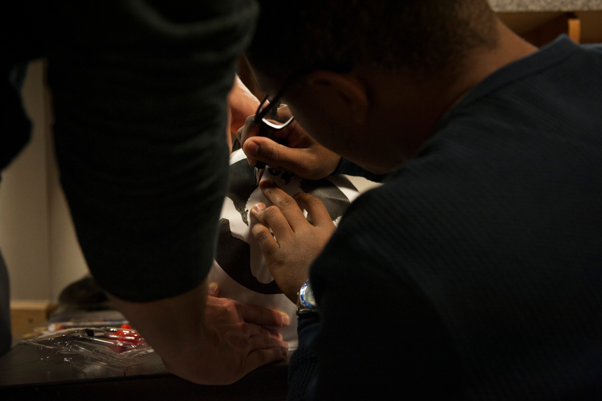 PETERSON AIR FORCE BASE, Colo. - Airman 1st Class Hersey Mayo, 21st Aerospace Medical Squadron public health technician, puts an outline on his pumpkin before cutting out the owl during a Peterson Chapel's 3rd Pumpkin Carving Contest at Patriot Hall, Oct. 28, 2015. Pumpkins and carving supplies were provided by the chapel. (U.S. Air Force photo by Senior Airman Rose Gudex)