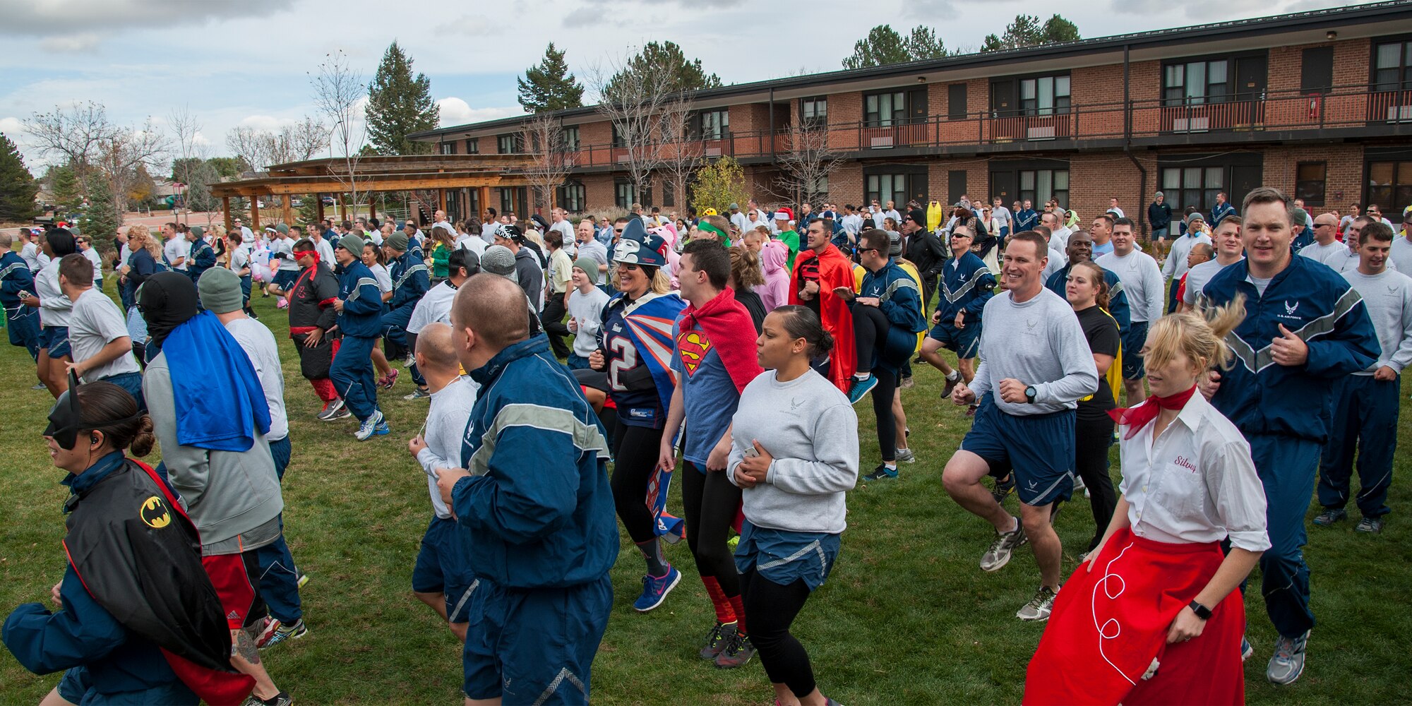 PETERSON AIR FORCE BASE, Colo. - Team Pete personnel warm up in costume before the 21st Space Wing Warfit fun run Oct. 30, 2015. The 5K run started at The Club on Peterson Air Force Base and followed a trail around the golf course and finished back at The Club. Participants also had the opportunity to take part in the Final Friday activities after the run. (U.S. Air Force photo by Craig Denton)