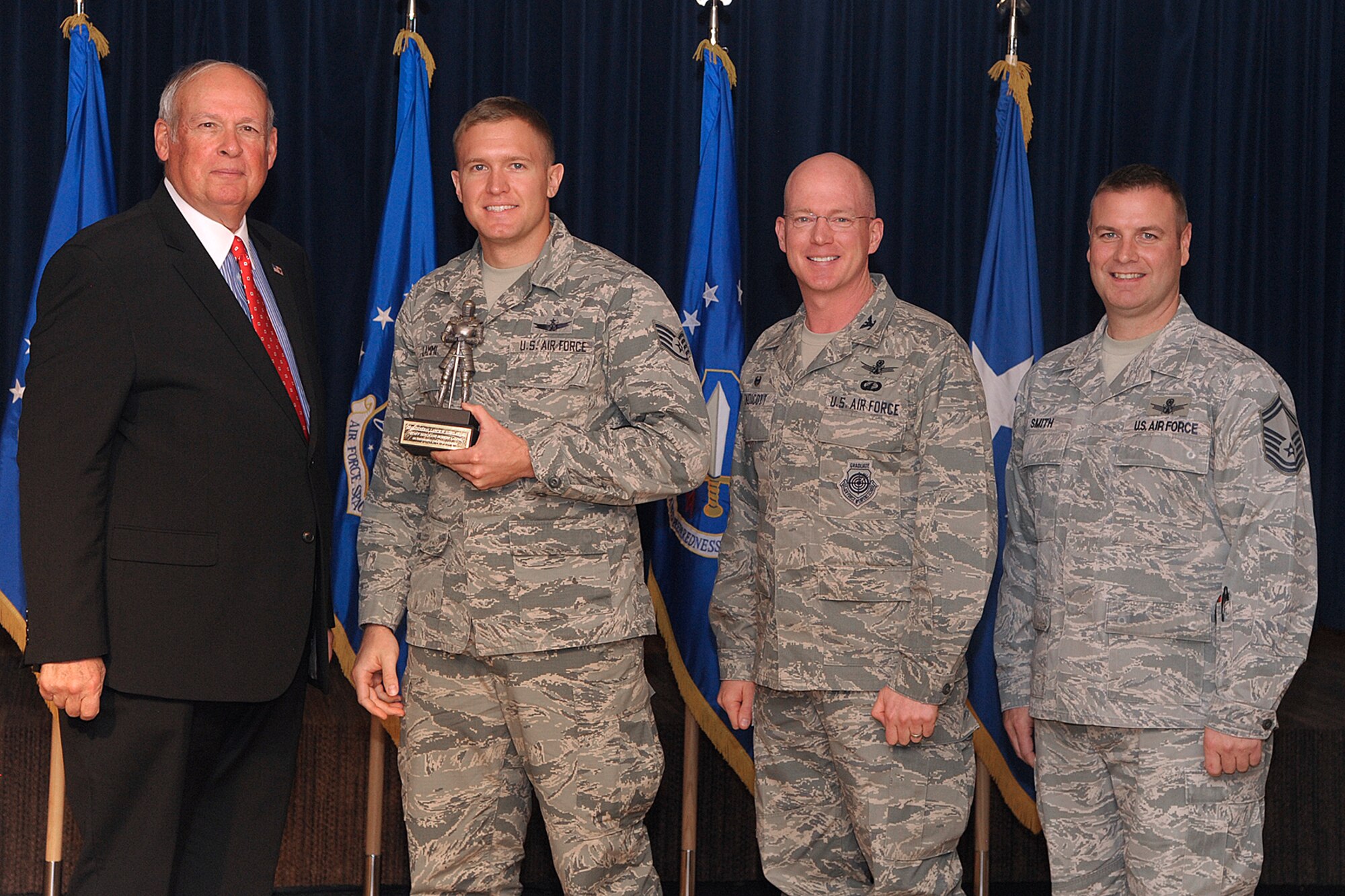 PETERSON AIR FORCE BASE, Colo. – Staff Sgt. Robert Lammi, 16th Space Control Squadron, (second from left) receives the General Lance W. Lord Award for the enlisted category from retired Gen. Lord at an awards ceremony at the Peterson Club, Oct. 26, 2015. The award recognized Airmen in the 21st Operations Group exceeding their peers in job performance, professionalism and dedication. Lammi was the only recipient of four who physically works at Peterson AFB, while the others are located at 21st Space Wing’s geographically separated units in Massachusetts, Florida and California. (U.S. Air Force photo by Duncan Wood))