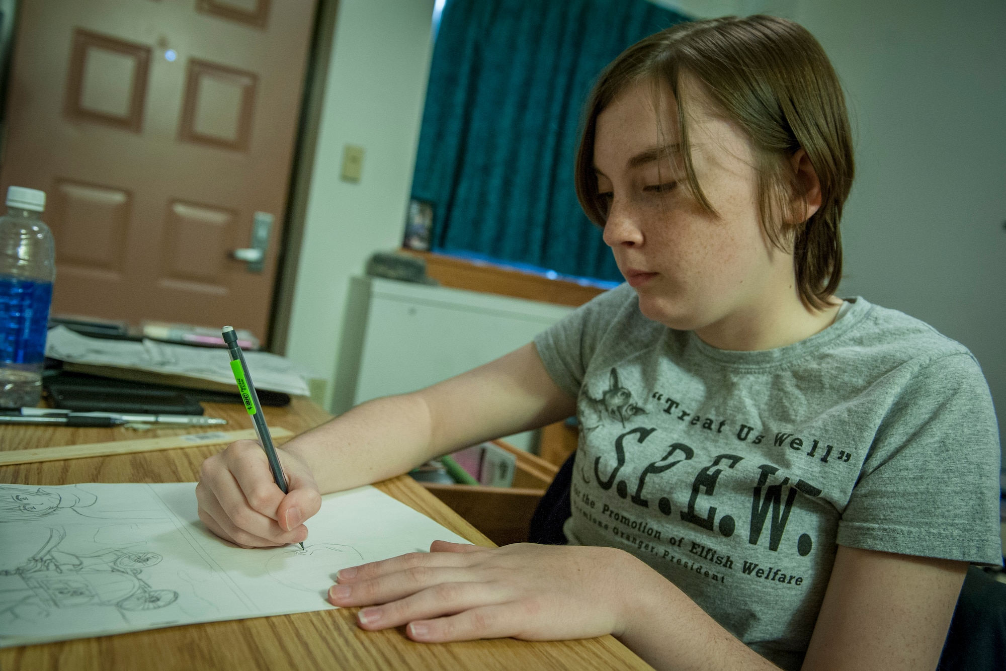 PETERSON AIR FORCE BASE, Colo. – Airman 1st Class Abby Morris, 21st Operations Support Squadron airfield management apprentice, works on a manga story during her off-time in her dorm Nov. 2, 2015. Morris began drawing when she was just 8 years old and is currently working on five different stories. (U.S. Air Force photo by Senior Airman Rose Gudex)