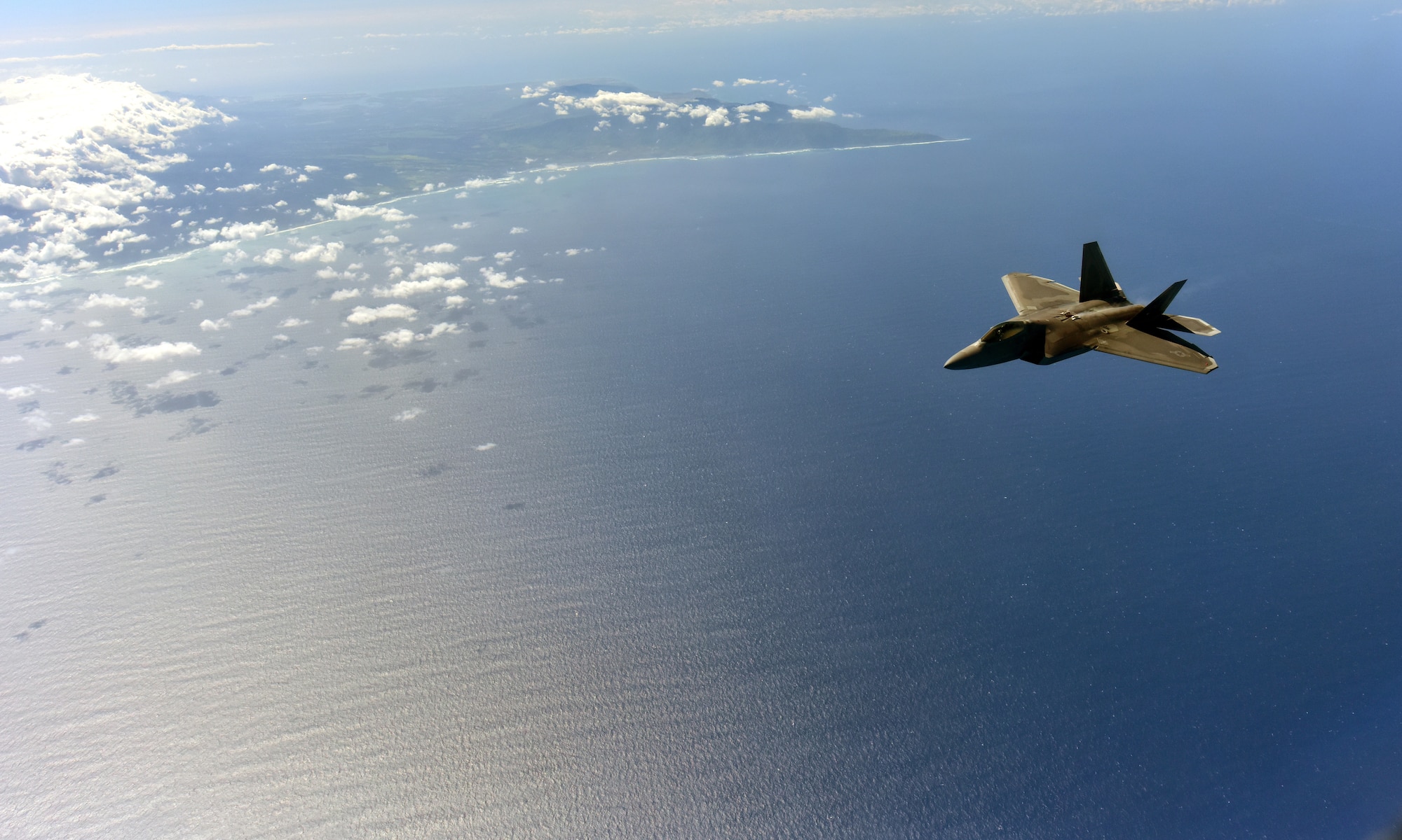 An F-22 Raptor from the 199th Fighter Wing as it soars over the island of Oahu as a part of Warrior Day exercises at Joint Base Pearl Harbor-Hickam, Hawaii, October 28, 2015. (U.S. Air Force photo by Staff Sgt. Christopher Stoltz/Released)