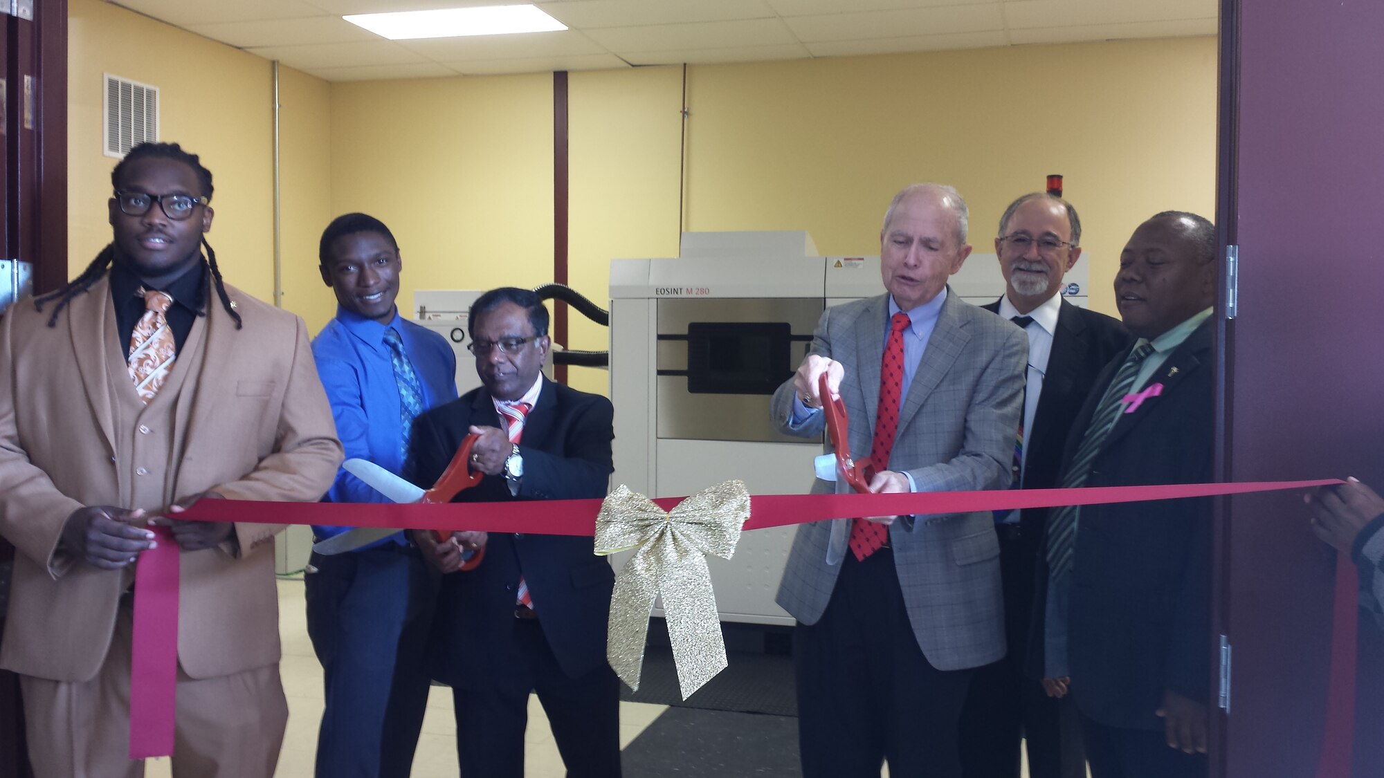 The Air Force Research Laboratory, Central State University (CSU), and Universal Technology Corporation (UTC) cut the ribbon for the new Additive Manufacturing Laboratory, making CSU the first university in the region with metal additive manufacturing capability.  Pictured from left to right are CSU students Mr. Jamal Robinson and Mr. Priestly Schuler, Dr. Subramania Sritharan (Dean of Science and Engineering, CSU), Dr. Charles Browning (Chairperson, Department of Chemical and Materials Engineering, University of Dayton), Mr. Joe Sciabica (President, UTC), and Dr. Charles Wesley Ford, Jr. (Provost and VP, CSU).  (Photo courtesy of Central State University)