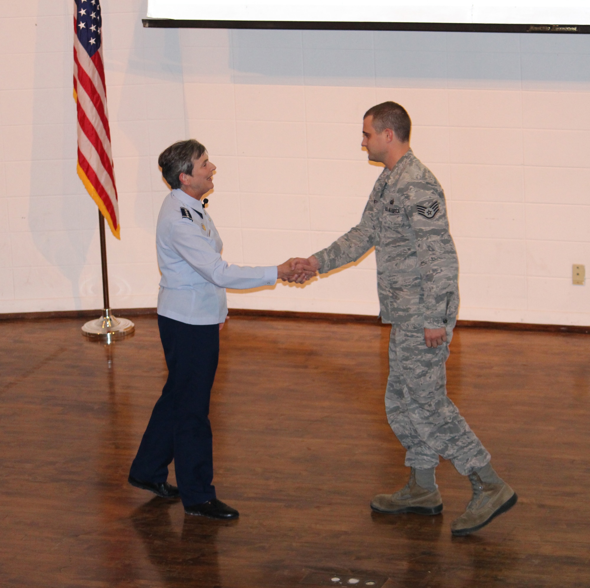 Gen. Ellen M. Pawlikowski (left), commander of Air Force Materiel Command, presents the Commander’s Coin to Staff Sgt. Jared Vanwey, AEDC Financial Management and Comptrollers Division, during the Arnold Air Force Base, Tenn., Commander’s Call at the University of Tennessee Space Institute auditorium Oct. 16, 2015. The general also presented coins to Clark Brandon, deputy of the AEDC Test Support Division, and 2nd Lt. Roy Fisher, of the Propulsion Wind Tunnel Test Branch. Commander’s Coins are presented to recognize a job well done. (U.S. Air Force photo/ Holly Fowler)