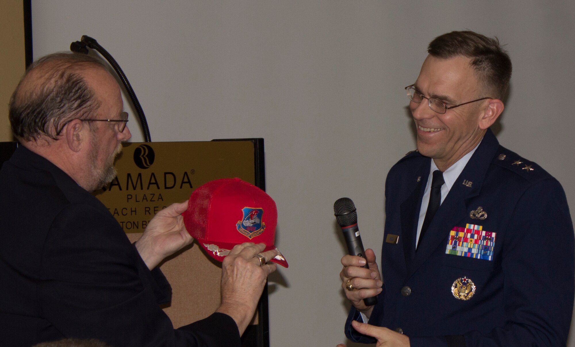 At right, Greg MacDougal, former REDHORSE Association president, presents Maj. Gen. Timothy Green with a ceremonial red hat during the association’s 50th anniversary convention in Fort Walton Beach, Florida.  (U.S. Air Force Photo/Mekka Parish/Released)