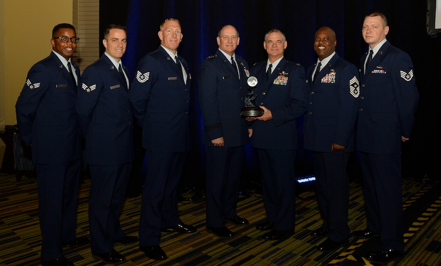 Lt. Gen. James F. Jackson, chief of the Air Force Reserve and commander, Air Force Reserve Command, poses with 302nd Airlift Wing commander, Col. Jay Pittman and 302nd AW Command Chief Master Sergeant Otis Jones, during the Lt. Gen. James E. Sherrard III Award presentation at the 47th Annual Air Mobility Command and Airlift/Tanker Association Symposium in Orlando, Fla., Oct. 31.  The 302nd AW was recognized for its overall contributions to the Mobility Air Force mission and total force. Outstanding performers selected by 302nd AW leadership to represent the wing (left to right) are: Senior Airmen, Howard Smith and Matthew Kenny, Tech Sgt. Christopher Meyer, (Lt. Gen James F. Jackson, Col. Jay Pittman, Chief Master Sgt. Otis Jones) and Staff Sgt. Curtis LeMay. (U.S. Air Force photo/Tech. Sgt. Peter Dean)