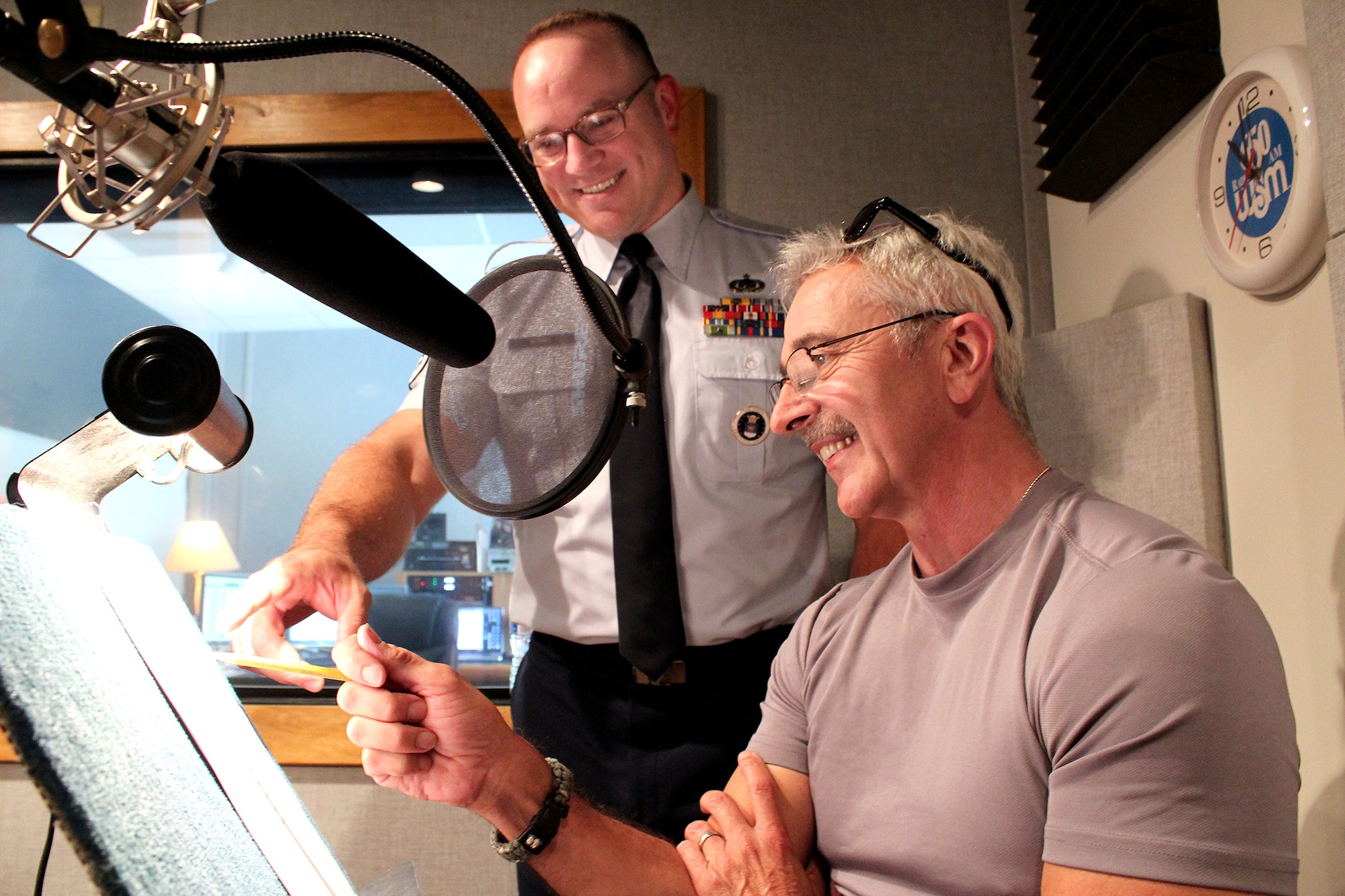 Master Sgt. Harry Kibbe and country star Aaron Tippin prepare to record the 2015 “Red, White and Air Force Blue Christmas” radio special at Spotland Productions in Nashville. The one-hour program is being distributed to country radio stations in the United States and the American Forces Network for airing during the upcoming holiday season. (U.S. Air Force photo/Dale Eckroth) 
