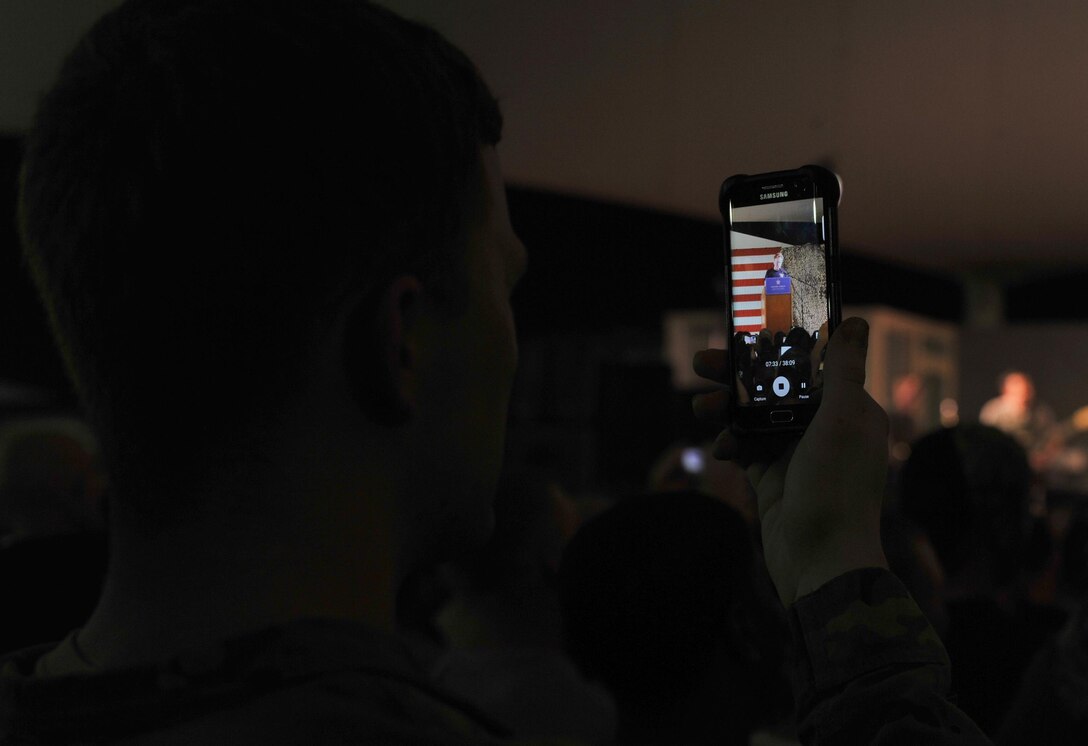 A member of the audience records a comic set by Conan O'Brien during an event at Al Udeid Air Base, Qatar, Nov. 3, 2015. The event consisted of O'Brien serving as host to a group of comedians and musical guest Grace Potter. (U.S. Air Force photo by Tech. Sgt. Joshua Strang)