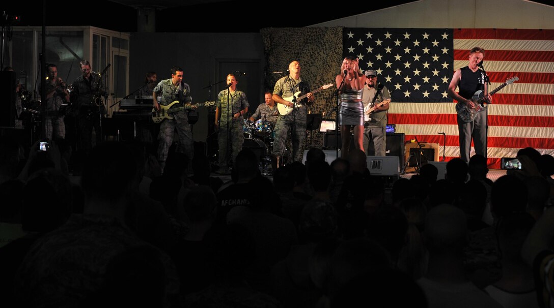Conan O'Brien, O'Brien's house band leader Jimmy Vivino, Grace Potter and the AFCENT band play together during an event at Al Udeid Air Base, Qatar, Nov. 3, 2015. The band served as the house band during the event as well as providing backup for Potter. (U.S. Air Force photo by Tech. Sgt. Joshua Strang)