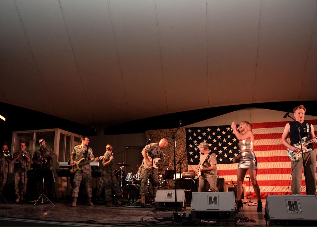 Conan O'Brien, O'Brien's house band leader Jimmy Vivino, Grace Potter and the AFCENT band play together during an event at Al Udeid Air Base, Qatar, Nov. 3, 2015. The band served as the house band during the event as well as providing backup for Potter. (U.S. Air Force photo by Master Sgt. Jeffrey Saunders)