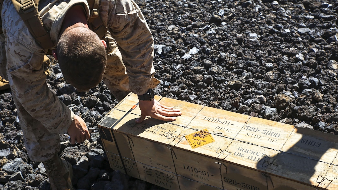 A Marine with Weapons Company, 3rd Battalion, 3rd Marine Regiment, unloads a tube-launched, optically-tracked, wire-guided missile during exercise Lava Viper, one of the staples of their pre-deployment training, at Pohakuloa Training Area, Hawaii, Oct. 23, 2015. Lava Viper provides the Hawaii-based Marines with an opportunity to conduct various movements, live-fire and tactical training before departing for Integrated Training Exercise aboard Marine Air-Ground Combat Center Twentynine Palms, Calif., where the battalion will train and be evaluated as a whole. "Trinity" strives to fight and win on both the tactical and ethical battlefield, always cultivating the values of honor, courage, and commitment, ultimately producing morally guided citizens whose obligations and responsibilities supersede rights and privileges.